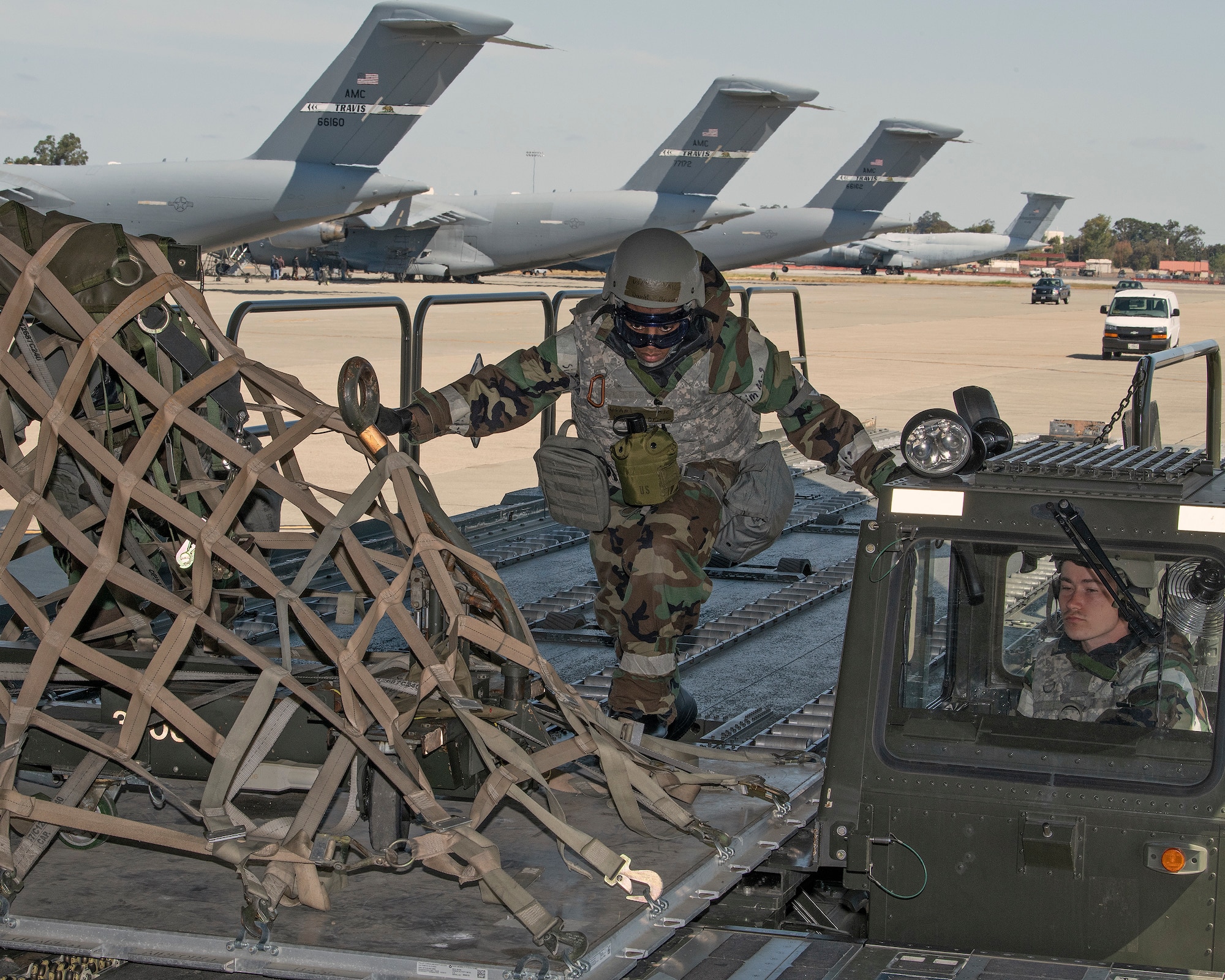 U.S. Air Force Airmen assigned to the 60th Aerial Port Squadron perform a cargo load during a readiness exercise at Travis Air Force Base, California, May 7, 2019. The base conducted a week-long exercise that evaluated Travis’ readiness and ability to execute and sustain rapid global mobility around the world. (U.S. Air Force photo by Louis Briscese)