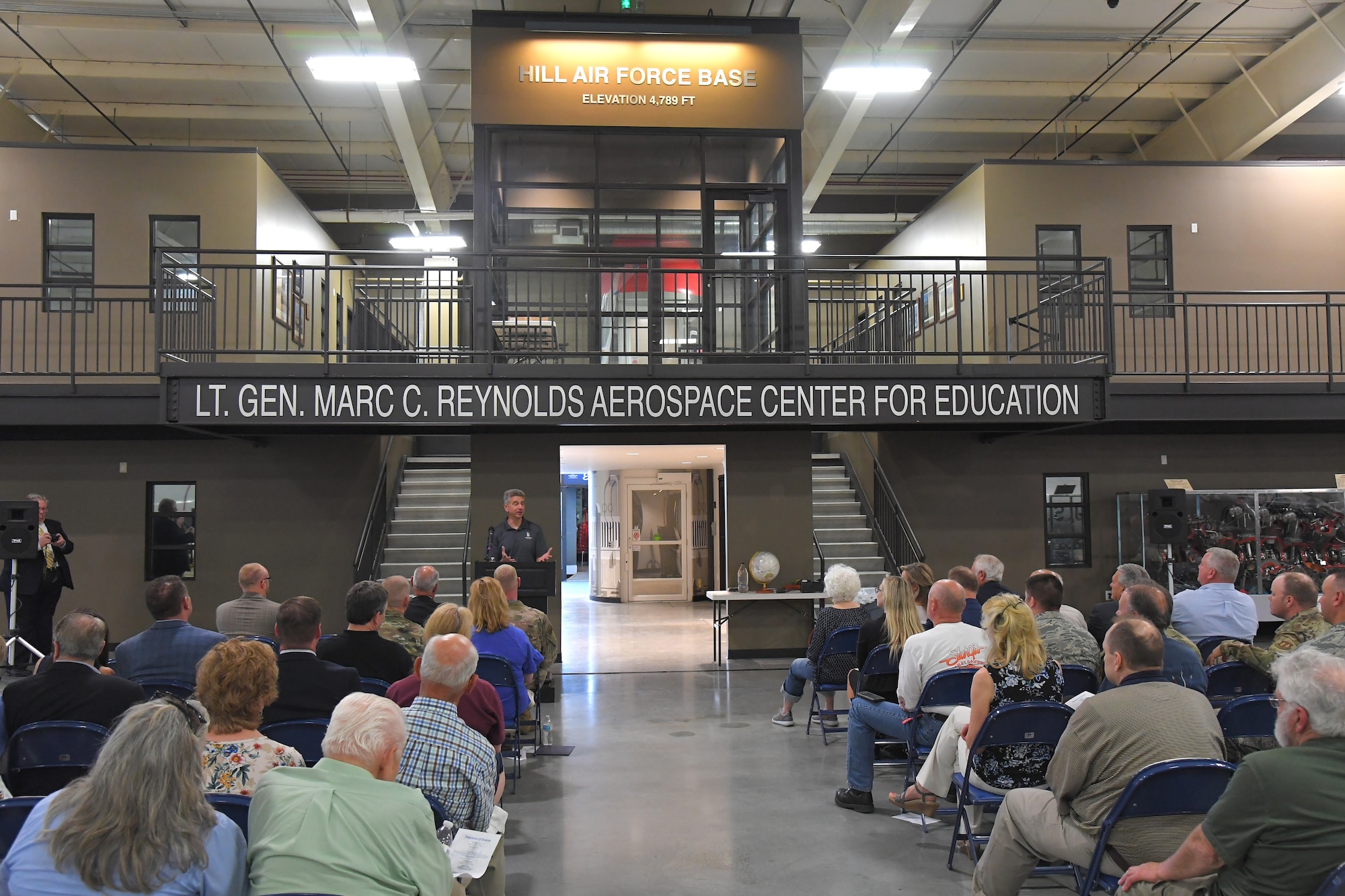 Mark Standing, Hill Aerospace Museum education director, addresses guests during a ceremony to mark the opening of the “The C-130 Experience” inside the Hill Aerospace Museum May 14, 2019, at Hill Air Force Base, Utah. The museum worked with base and community partners for several years to convert the C-130 aircraft fuselage into an interactive classroom. The major focus of the learning center curriculum will include the history of the aircraft, beginning in the 1960s through present day, and the important part it’s played in the Air Force and in the defense of the country.  (U.S. Air Force photo by Todd Cromar)