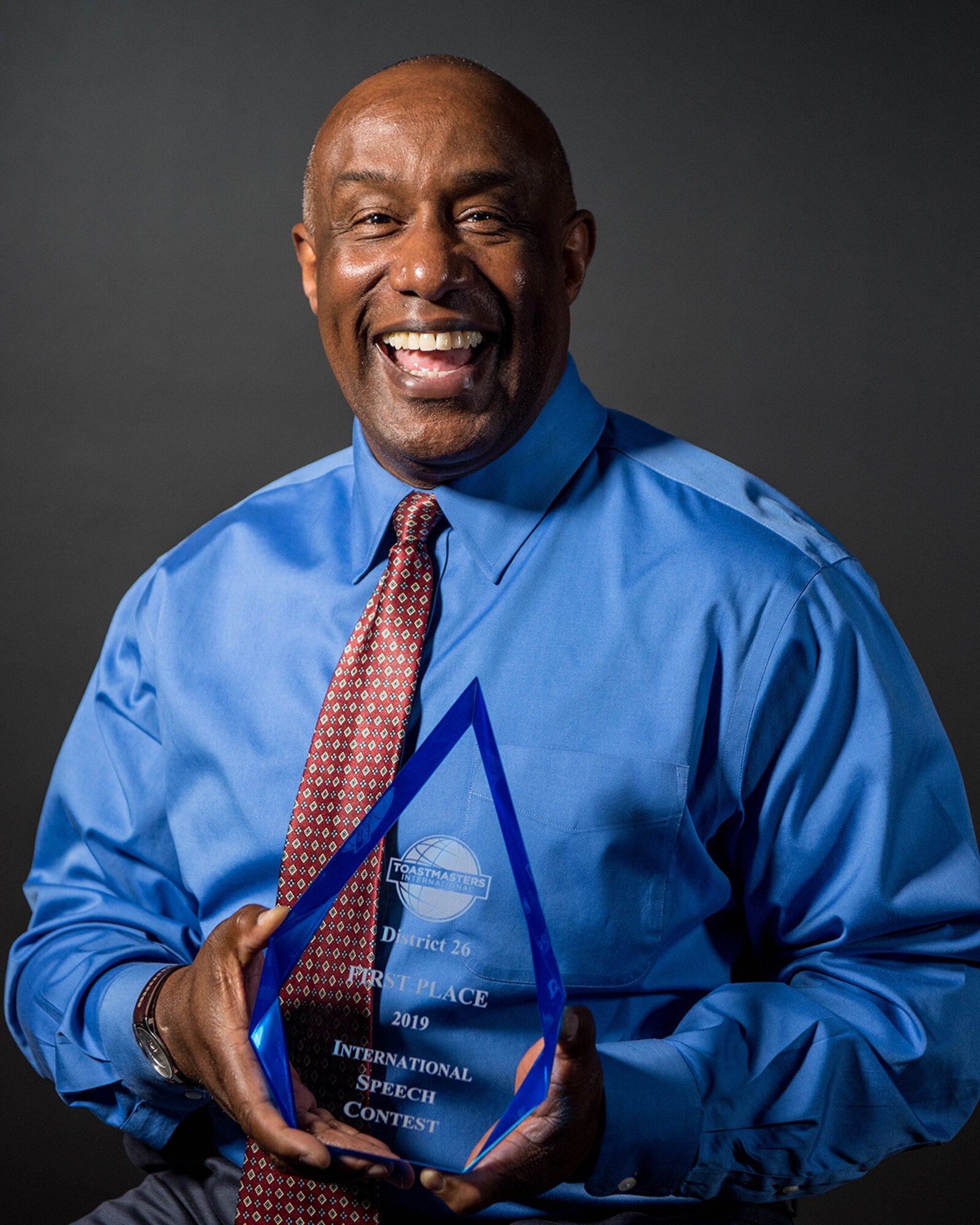 Greg Williams, legislative liaison at Headquarters, Air Force Space Command, poses with his Toastmasters International District 26 first place trophy at Peterson Air Force Base, Colorado, May 9, 2019. (U.S. Air Force photo by Amber Whittington)
