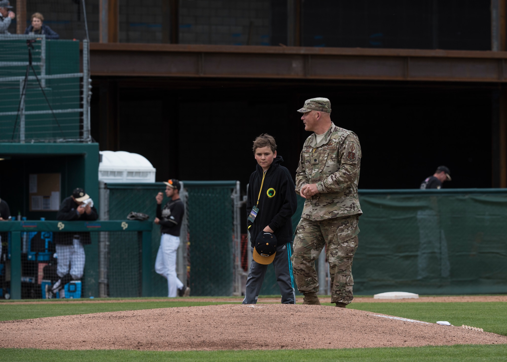 Lt. Col. Steven Kimel, 216th Space Control Squadron commander, approaches the pitcher’s mound with his son to throw the first pitch during the California Polytechnic State University Hero’s Night baseball game May 7, 2019, at the Alex G. Spanos Stadium in San Luis Obispo, Calif. The game was dedicated as “Hero’s Night” to honor all military, law enforcement and fire personnel. (U.S. Air Force photo by Airman 1st Class Aubree Milks)