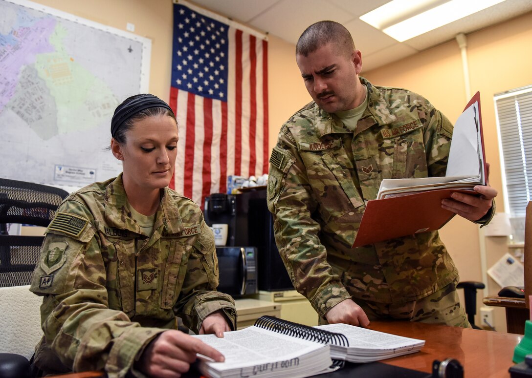 Airman with 455th Air Expeditionary Wing Legal Office Superintendent (left) looks over Manual for Courts-Martial guide with Airman NCO-in-Charge of
General Law, at Bagram Air Field, Afghanistan, March 17, 2016 (U.S. Air Force/Nicholas Rau)