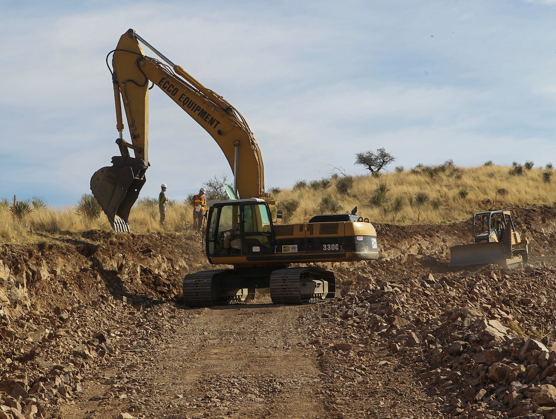 Marines assigned to Engineer Company, Marine Wing Support Squadron 272, Marine Corps Air Station New River, North Carolina, use excavator to reserve road being constructed near U.S./Mexico border, March 18, 2013 (U.S. Marine Corps/Manuel Estrada)