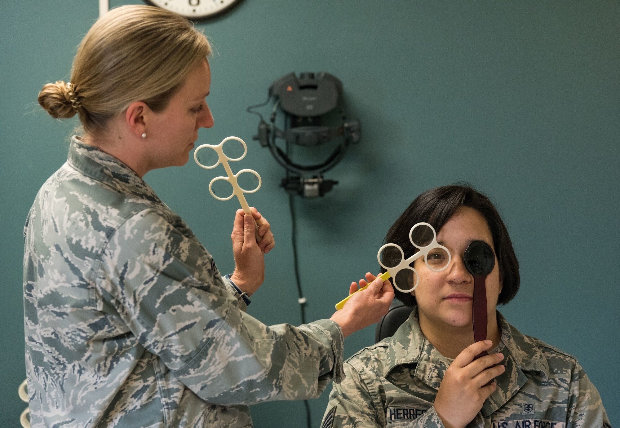 U.S. Air Force Maj. Carli Murphy, 436th Aerospace Medicine Squadron optometry flight commander, performs a test on Staff Sgt. Courtney Herrera, 436th Medical Support Squadron radiologic technologist, during a routine eye examination May 8, 2019, at the Optometry Clinic on Dover Air Force Base, Del. The test allowed Murphy to refine Herrera’s contact lens prescription. (U.S. Air Force photo by Roland Balik)