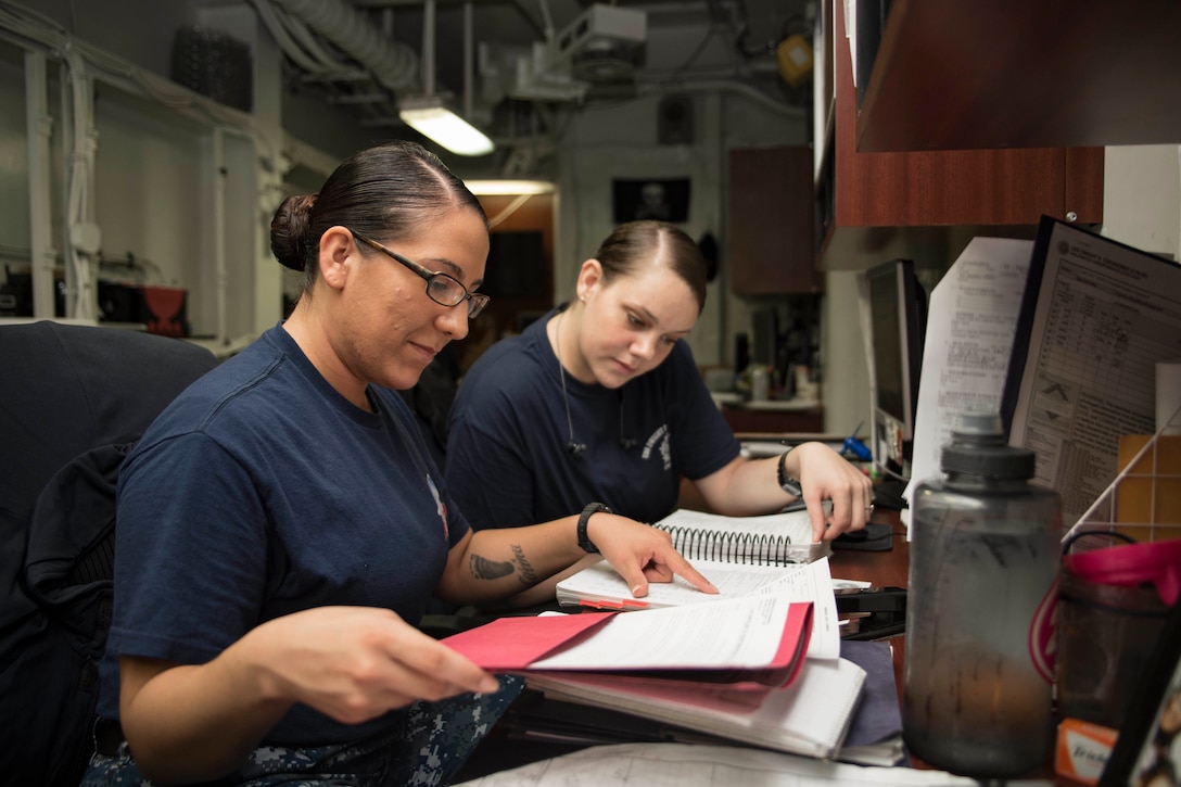 Servicemembers review Manual for Court Martial in legal office of USS Dwight D. Eisenhower, deployed in support of Operation Inherent Resolve, maritime security operations, and theater security cooperation efforts, Arabian Gulf, August 11, 2016 (U.S. Navy/Joshua Murray)