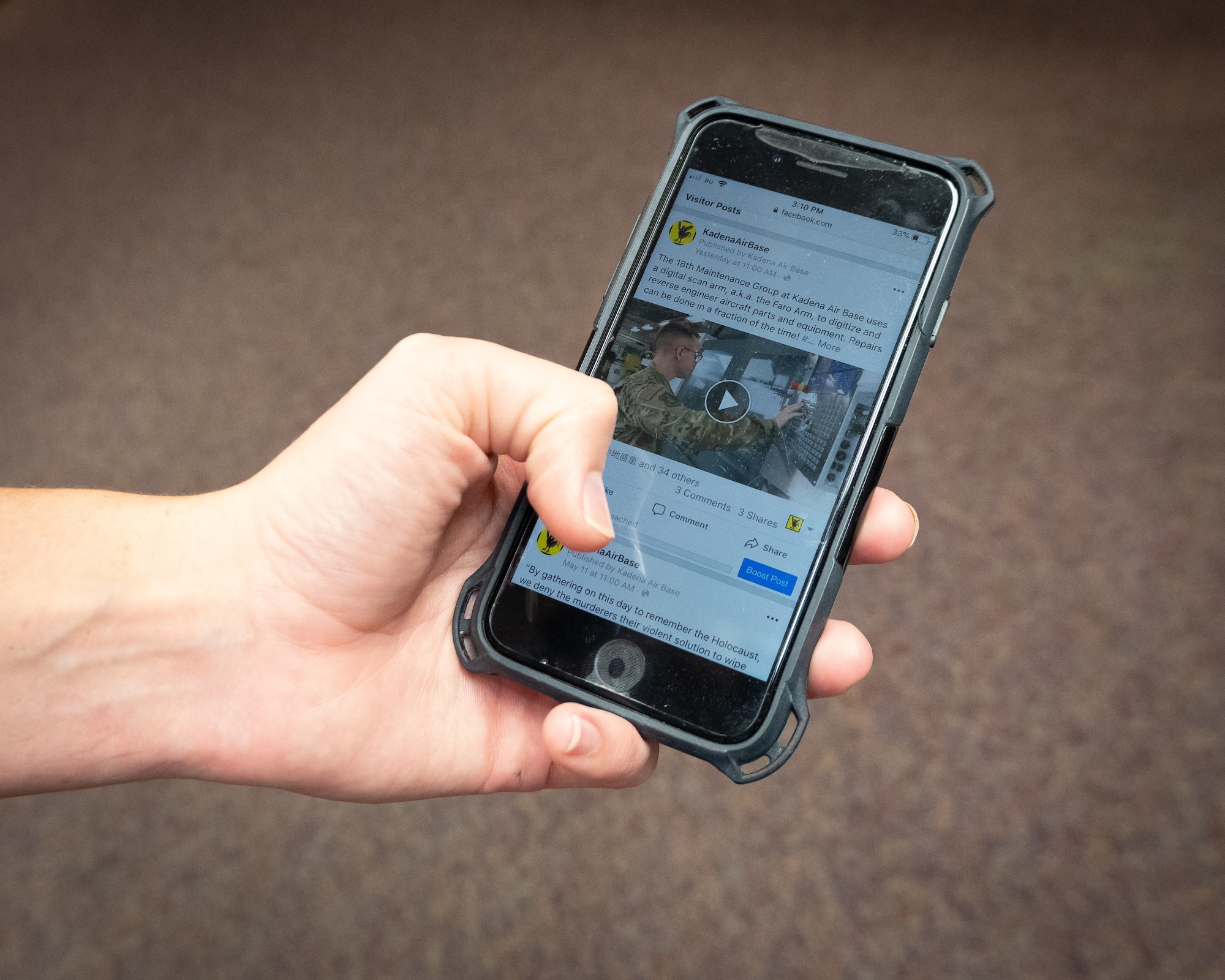 Senior Airman Kristan Campbell, photojournalist assigned to the 18th Wing Public Affairs office, scrolls through social media on her smartphone at Kadena Air Base, Japan, May 14, 2019.