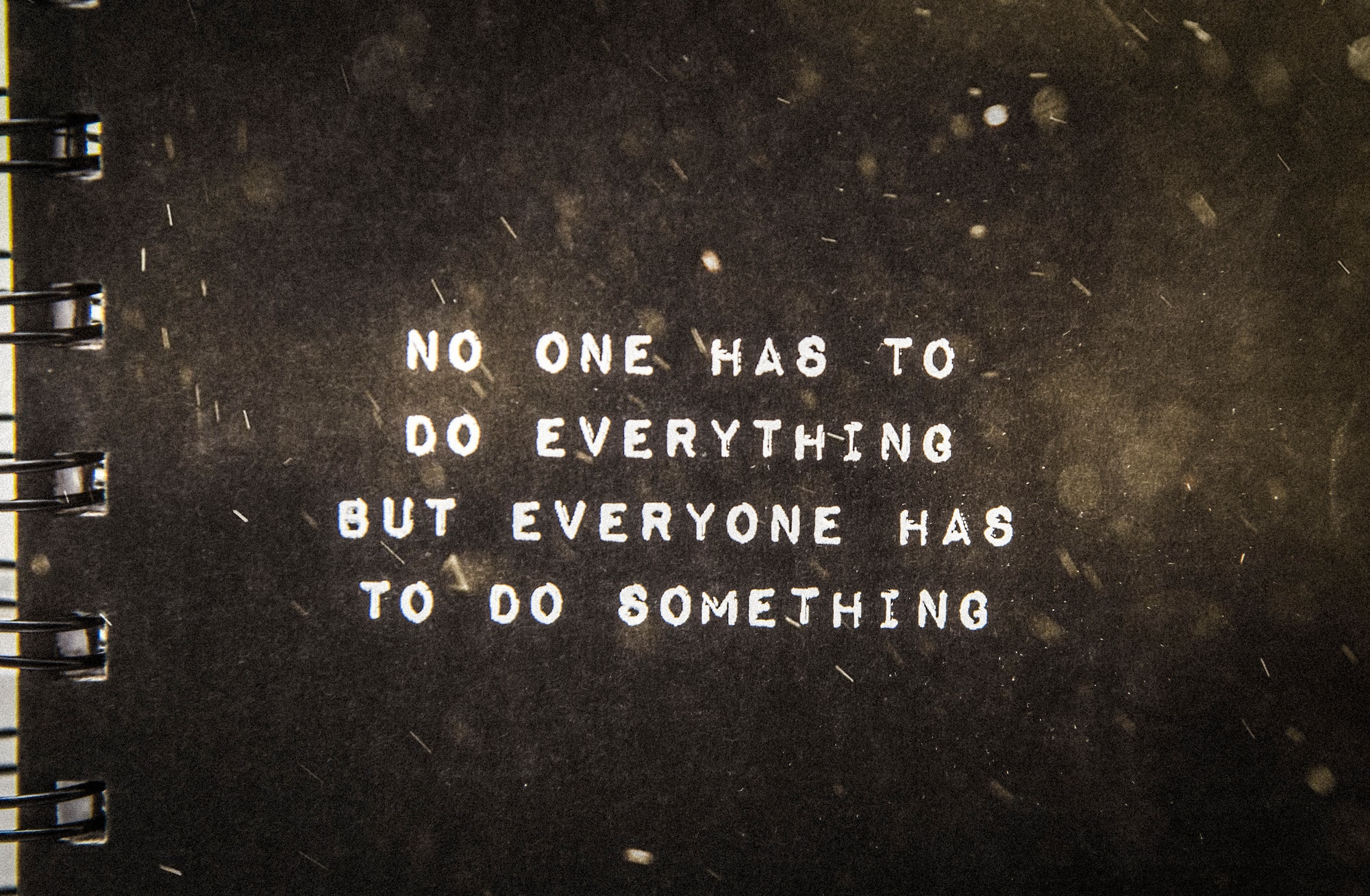 A notebook displaying a suicide awareness message sits on a desk at Misawa Air Base, Japan, May 9, 2019. The quote, originally from Max Lucado’s book “God is With You Every Day”, means it is not the sole responsibility of one person to take care of those who need help; everyone should have compassion to help others. (U.S. Air Force photo illustration by Senior Airman Sadie Colbert)