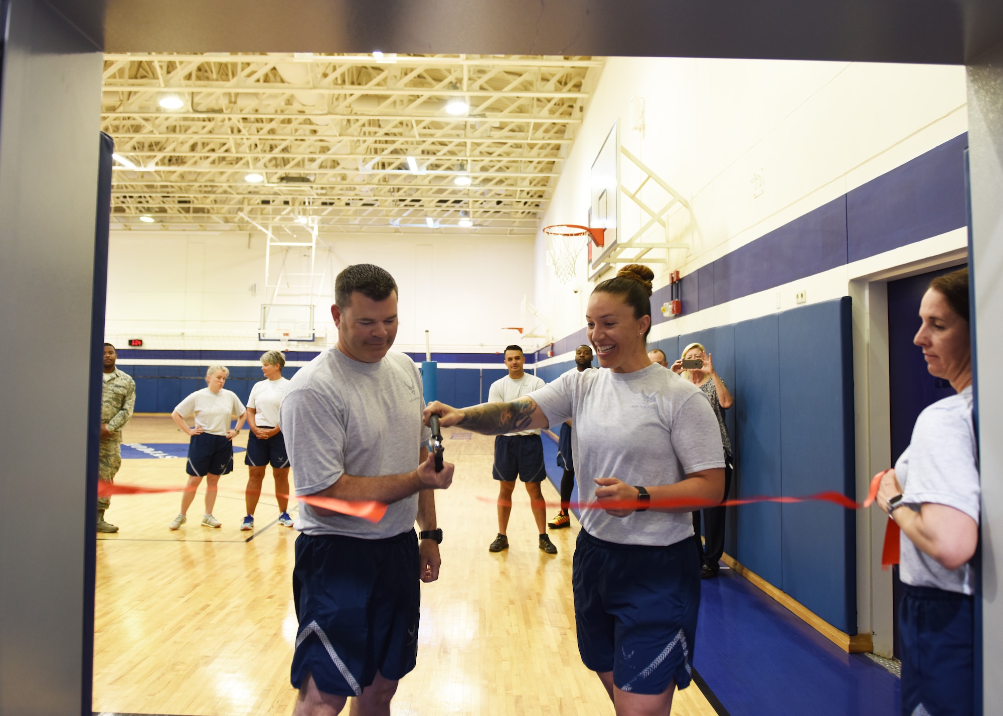 Col. Brian Filler, 39th Air Base Wing vice commander (left), and Tech. Sgt. Elizabeth Corpus, 39th ABW command section NCO in charge, conduct a ribbon-cutting ceremony at the Larger than Life Fitness Center on May 15, 2019, at Incirlik Air Base, Turkey. Through the combined efforts of the command staff, Force Support Squadron, and Civil Engineer Squadron, the fitness center underwent a 47-day renovation focused on accommodating specific physical fitness requirements of battlefield Airmen. (U.S. Air Force photo by Senior Airman Joshua Magbanua)