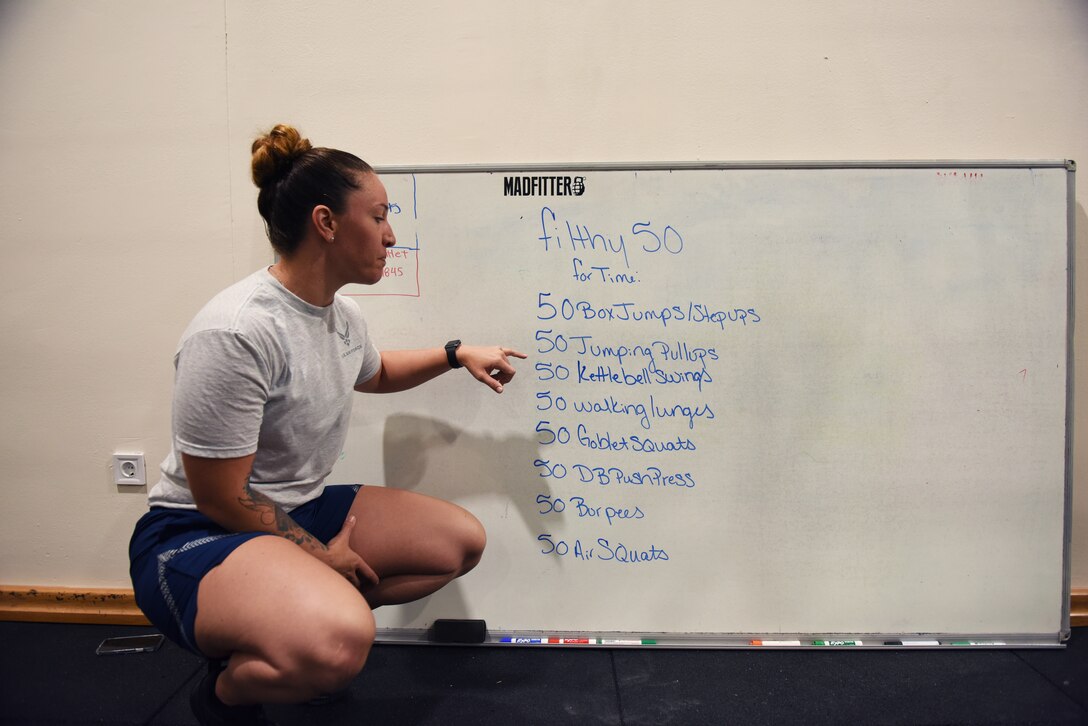 Tech. Sgt. Elizabeth Corpus, 39th Air Base Wing command section NCO in charge, explains the “workout-of-the-day” at the Larger than Life Fitness Center weight room on May 15, 2019, at Incirlik Air Base, Turkey. Corpus initiated a 47-day renovation project of the weight room after noticing the need for more adequate features to accommodate the physical training needs of Airmen. (U.S. Air Force photo by Senior Airman Joshua Magbanua)