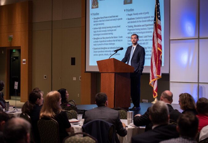 Chris Miller, Space and Naval Warfare Systems Center Atlantic executive director, addresses attendees during the Information Warfare Research Project Consortium Industry Day at Trident Technical College.