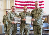 Commander, Naval Sea Systems Command Warfare Centers Rear Adm. Eric Ver Hage, presents Petty Officer 1st Class Joseph Rodriguez, Naval Surface Warfare Center Panama City Division (NSWC PCD) dive locker leading petty officer and diving supervisor, letter of commendation for Sailor of the Quarter during an All Hands at NSWC PCD May 1.