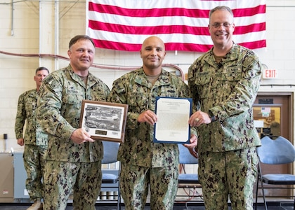 Commander, Naval Sea Systems Command Warfare Centers Rear Adm. Eric Ver Hage, presents Petty Officer 1st Class Joseph Rodriguez, Naval Surface Warfare Center Panama City Division (NSWC PCD) dive locker leading petty officer and diving supervisor, letter of commendation for Sailor of the Quarter during an All Hands at NSWC PCD May 1.