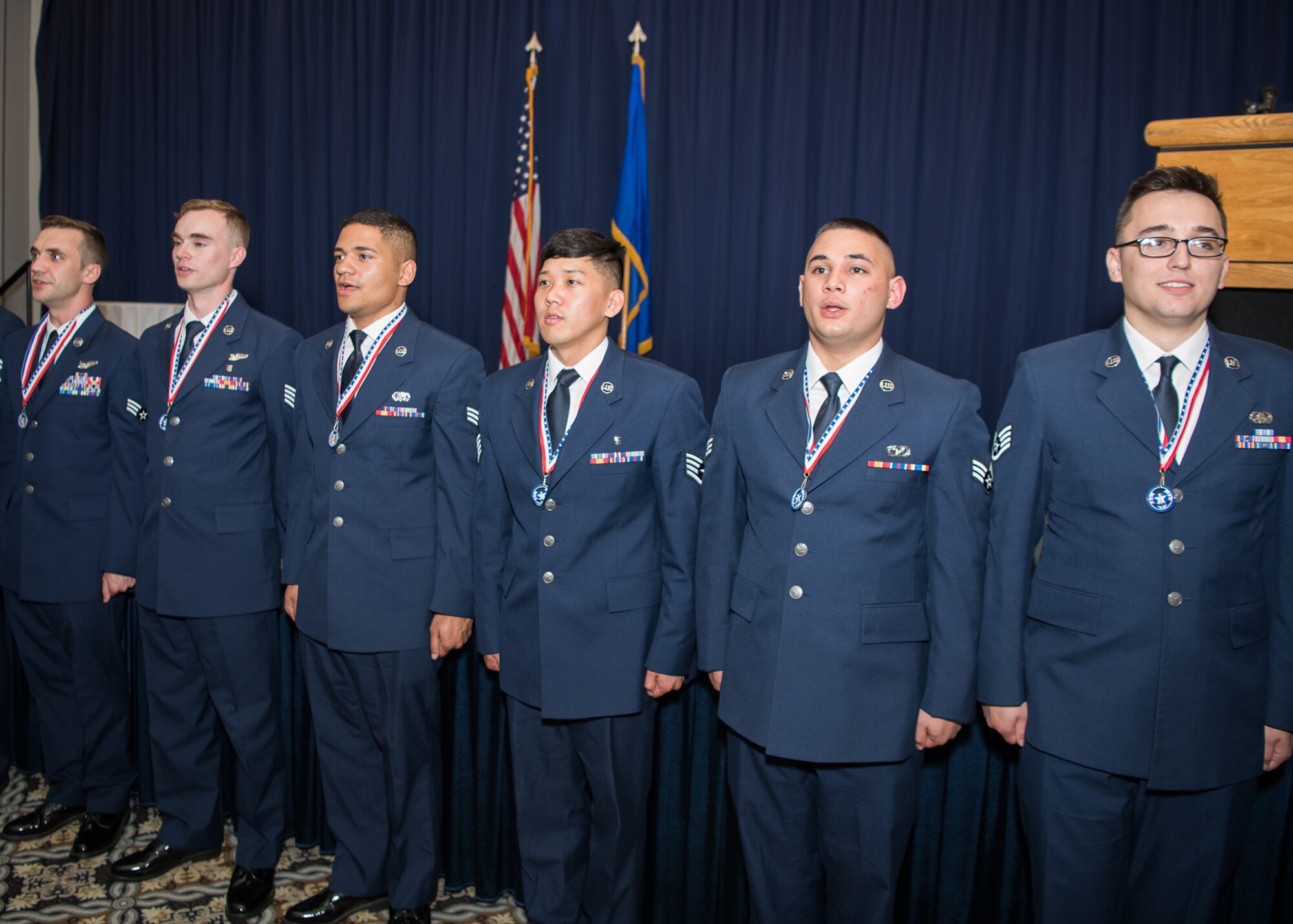 Team Dover Airmen sing the Air Force song, “Wild Blue Yonder,” at the conclusion of an Airman Leadership School graduation ceremony May 2, 2019, at Dover Air Force Base, Del. The school is a requirement for promotion into the noncommissioned officer ranks. (Official U.S. Air Force photo by Mauricio Campino)