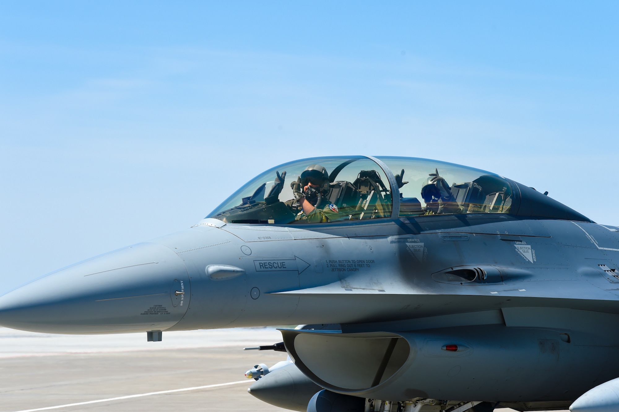 Maj. Benjamin “Chuck” Norwood (left), an instructor pilot assigned to the 149th Fighter Wing, and Staff Sgt. Barrett Stroud, a crew chief assigned to the 149th Aircraft Maintenance Squadron, give the Gunfighter salute during Coronet Bronco May 2 at Mountain Home Air Force Base, Idaho. The annual training event deploys members of the Air National Guard’s 149th FW, headquartered at Joint Base San Antonio-Lackland, to another environment in order to familiarize them with accomplishing mission objectives in an unfamiliar location.