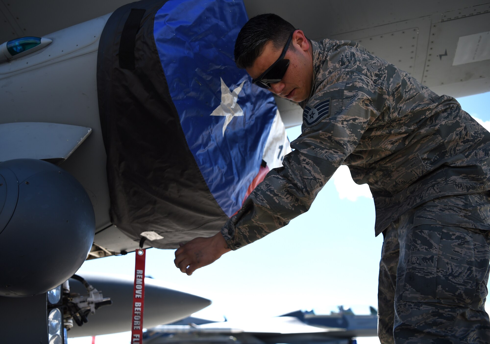 Staff Sgt. Geo Deleon, a crew chief assigned to the 149th Fighter Wing, Air National Guard, secures the intake cover of an F-16 Fighting Falcon during Coronet Bronco at Mountain Home Air Force Base, Idaho, April 29. The annual training event deploys members of the 149th Fighter Wing, headquartered at Joint Base San Antonio-Lackland, to another environment in order to familiarize them with accomplishing mission objectives in an unfamiliar location.