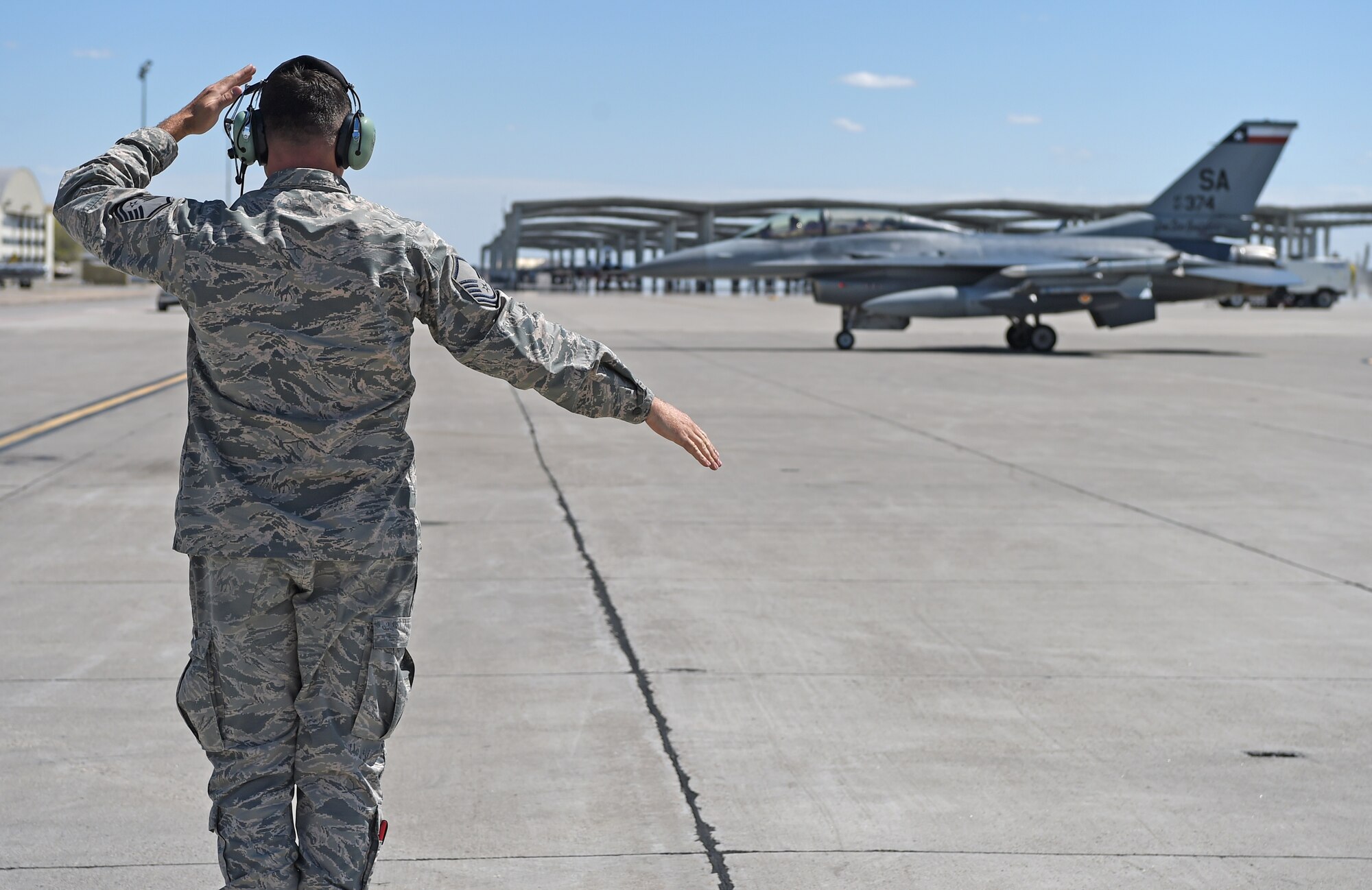 Master Sgt. Chris Hamilton, a crew chief assigned to the 149th Fighter Wing, Air National Guard, marshals in an F-16 Fighting Falcon during Coronet Bronco April 29 at Mountain Home Air Force Base, Idaho. The annual training event deploys members of the 149th Fighter Wing, headquartered at Joint Base San Antonio-Lackland, to another environment in order to familiarize them with accomplishing mission objectives in an unfamiliar location.