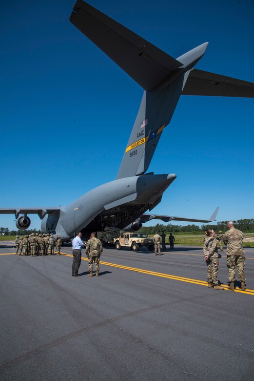 Citizen Airman of the 300th Airlift Squadron Joint Base Charleston, S.C. and Soldiers from the 414th Signal Company at Fort Stewart, Georgia, prepare to load a humvee and radar system on to a C-17 Globemaster III, May 14, 2019, at Wright Army Airfield. The humvee and radar system were loaded on to the C-17 as part of an Expeditionary Deployment Readiness Exercise. (U.S. Air Force photo by Senior Airman William Brugge)