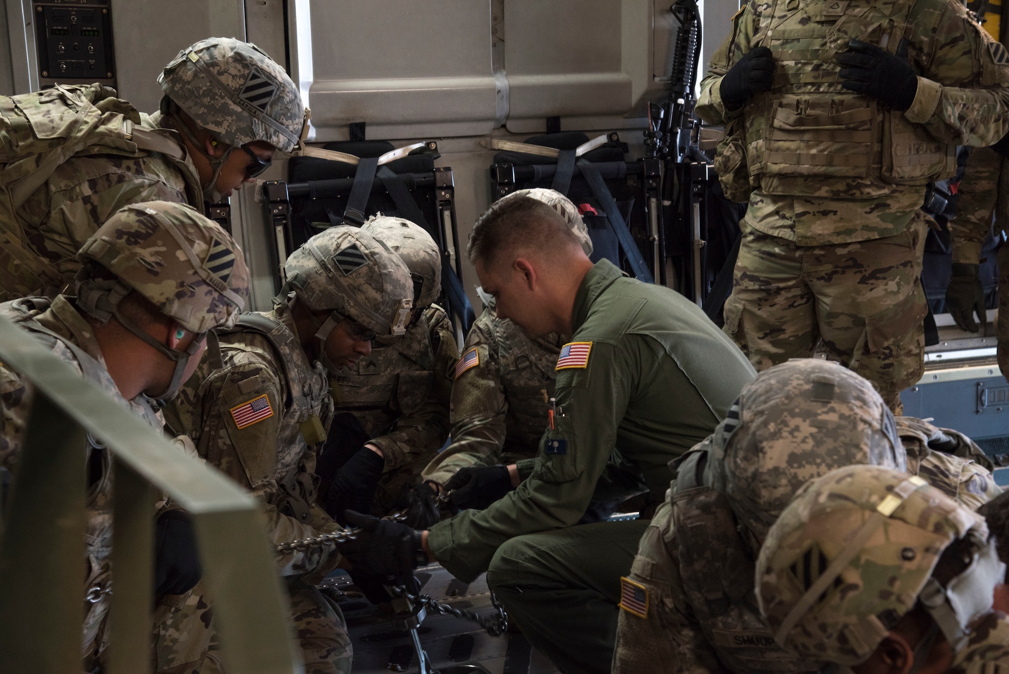 U. S. Air Force Senior Airman Branden Burkhart, loadmaster with the 300th Airlift Squadron Joint Base Charleston, S.C., teaches soldiers with the 414th Signal Company from Fort Stewart, Georgia how to secure equipment on a C-17 Globemaster III May 14, 2019, at Wright Army Airfield. The soldiers trained to be ready during an Expeditionary Deployment Readiness Exercise.(U.S. Air Force photo by Senior Airman William Brugge)