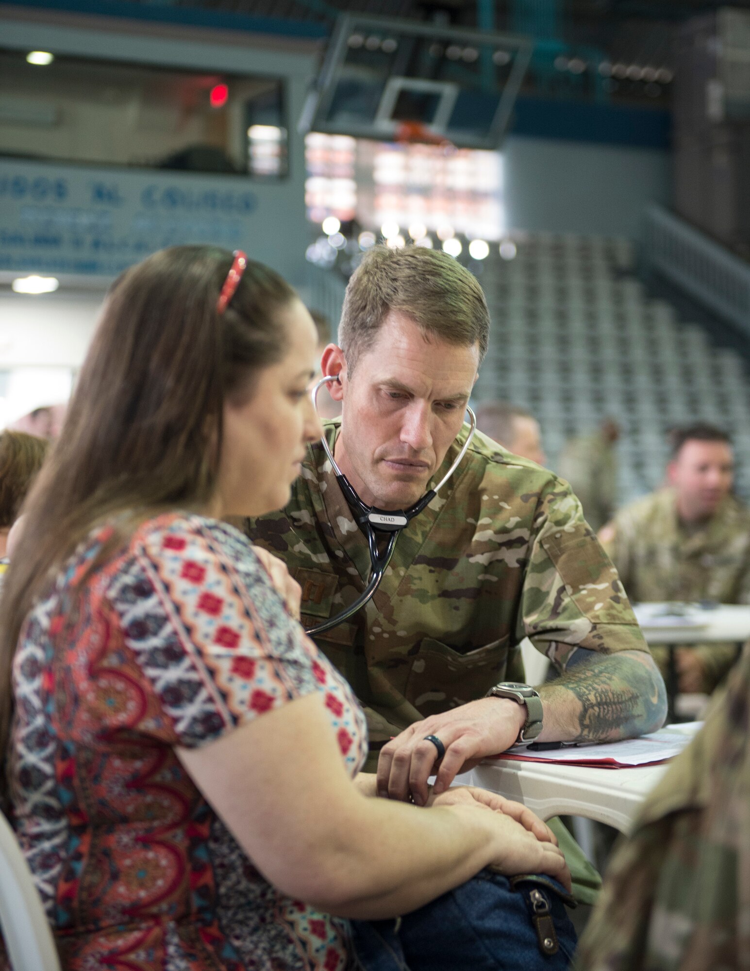 U.S. Air Force Capt. Chad Macheel, a medical provider with the 133rd Medical Group, checks the pulse of patients in Lares, Puerto Rico, April 30, 2019.