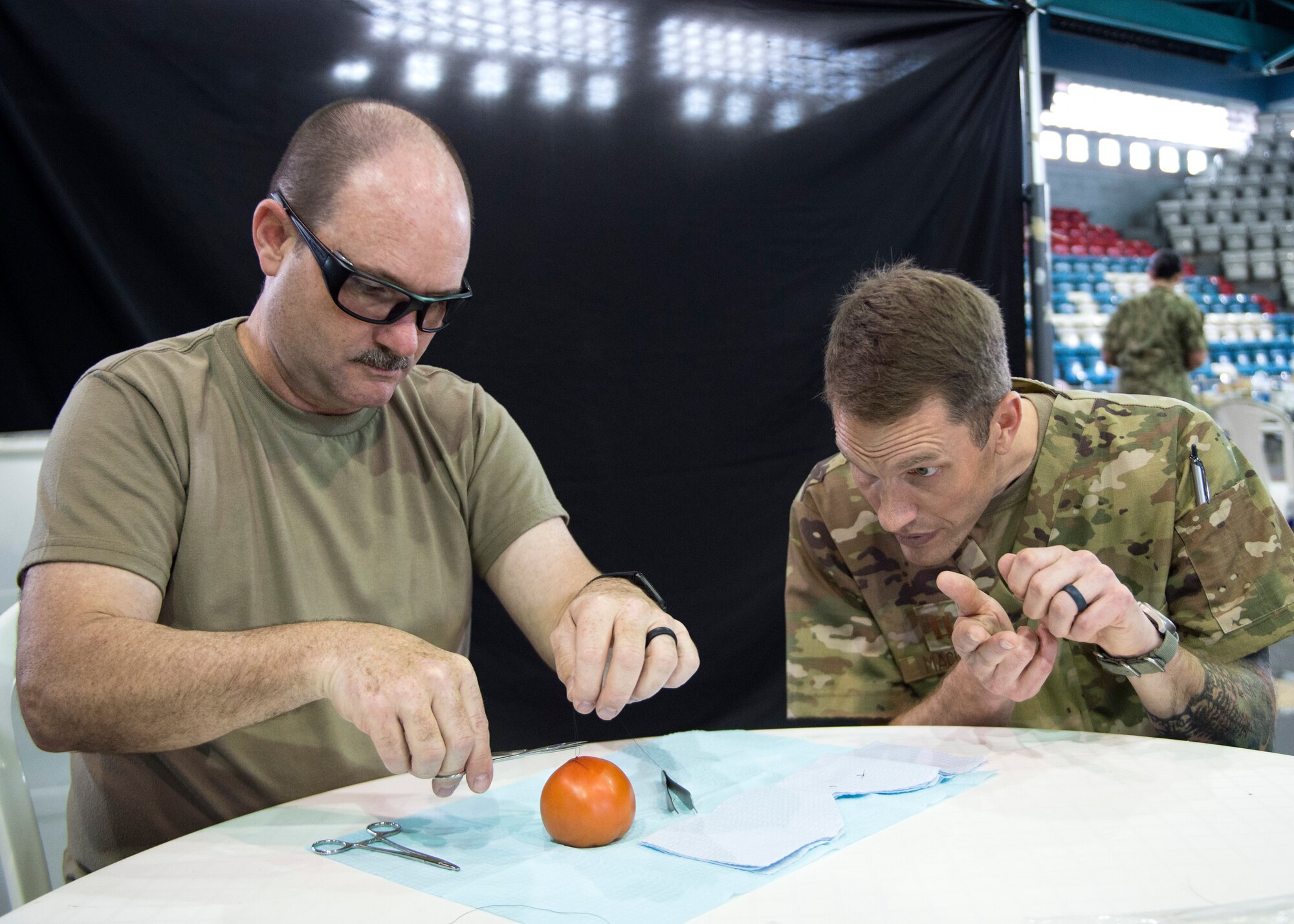U.S. Army Sgt. 1st Class Robert Abbott, an optometrist technician with the 335th Area Support Medical Company, 49th Multifunctional Medical Battalion, learns how to suture from U.S. Air Force Capt. Chad Macheel, a medical provider with the 133rd Medical Group, in Lares, Puerto Rico, May 2, 2019.