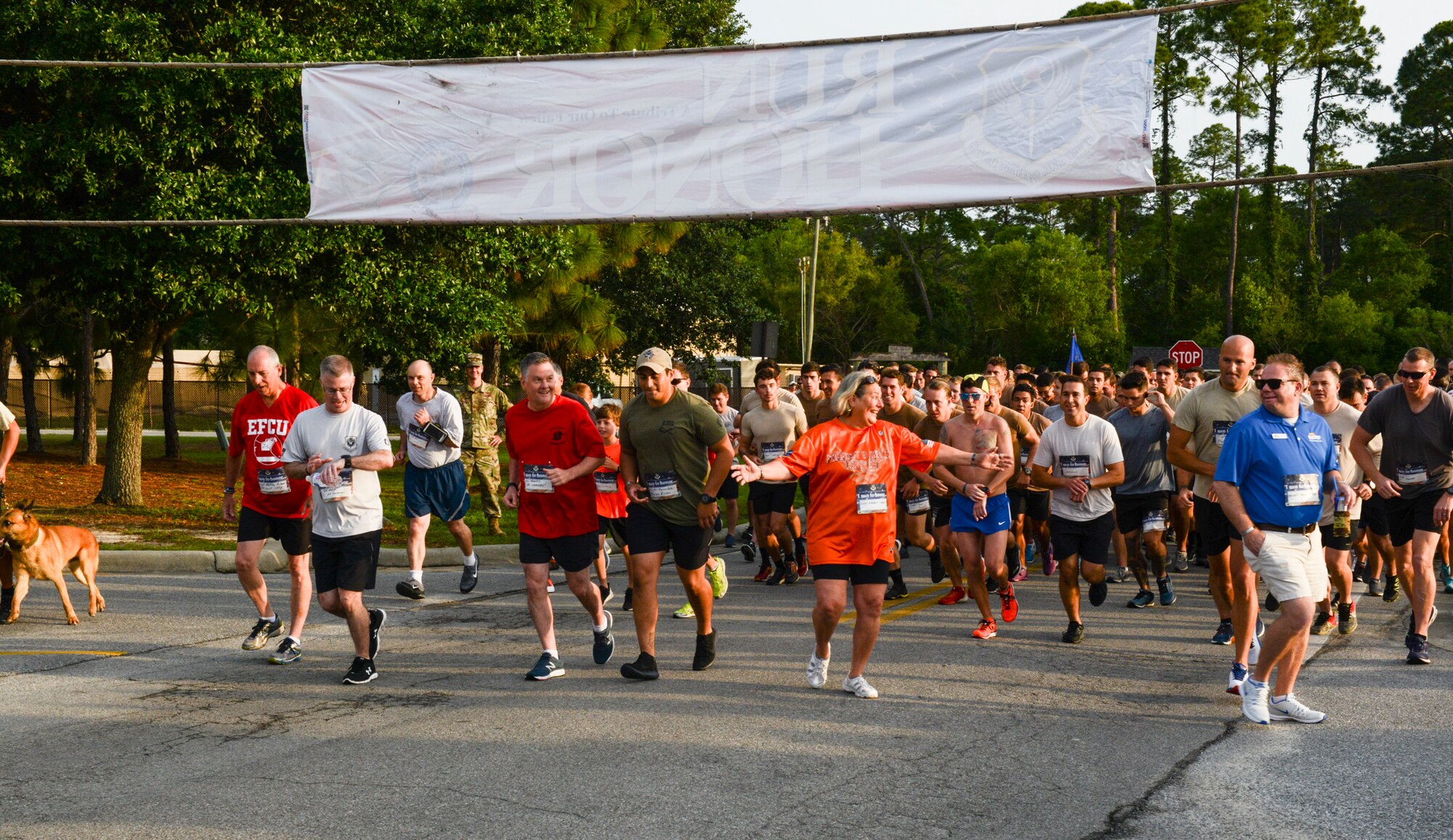 A group of people running down a road.