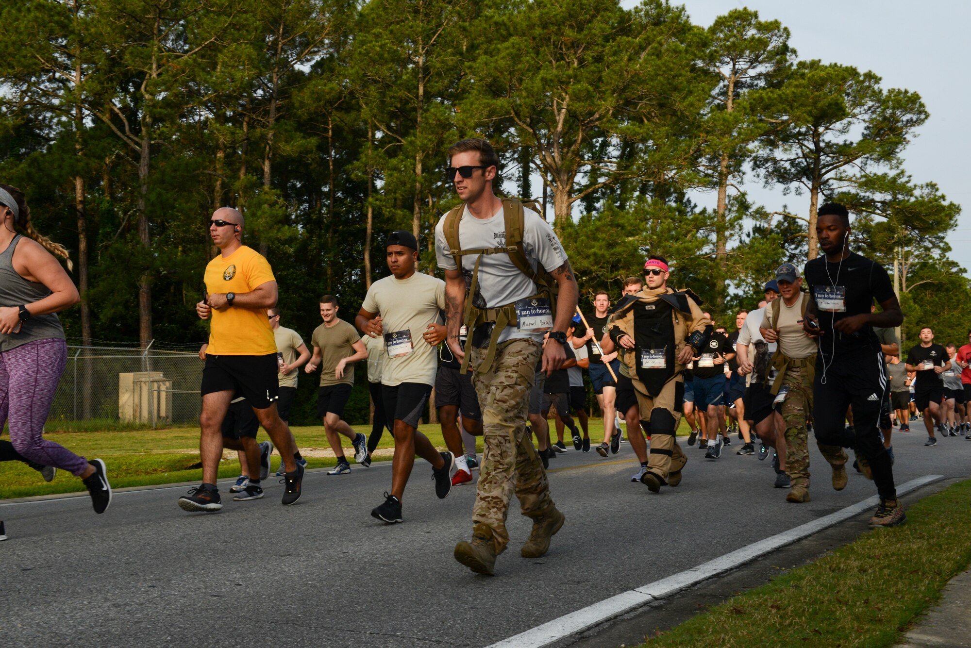 A group of people walking down a road.