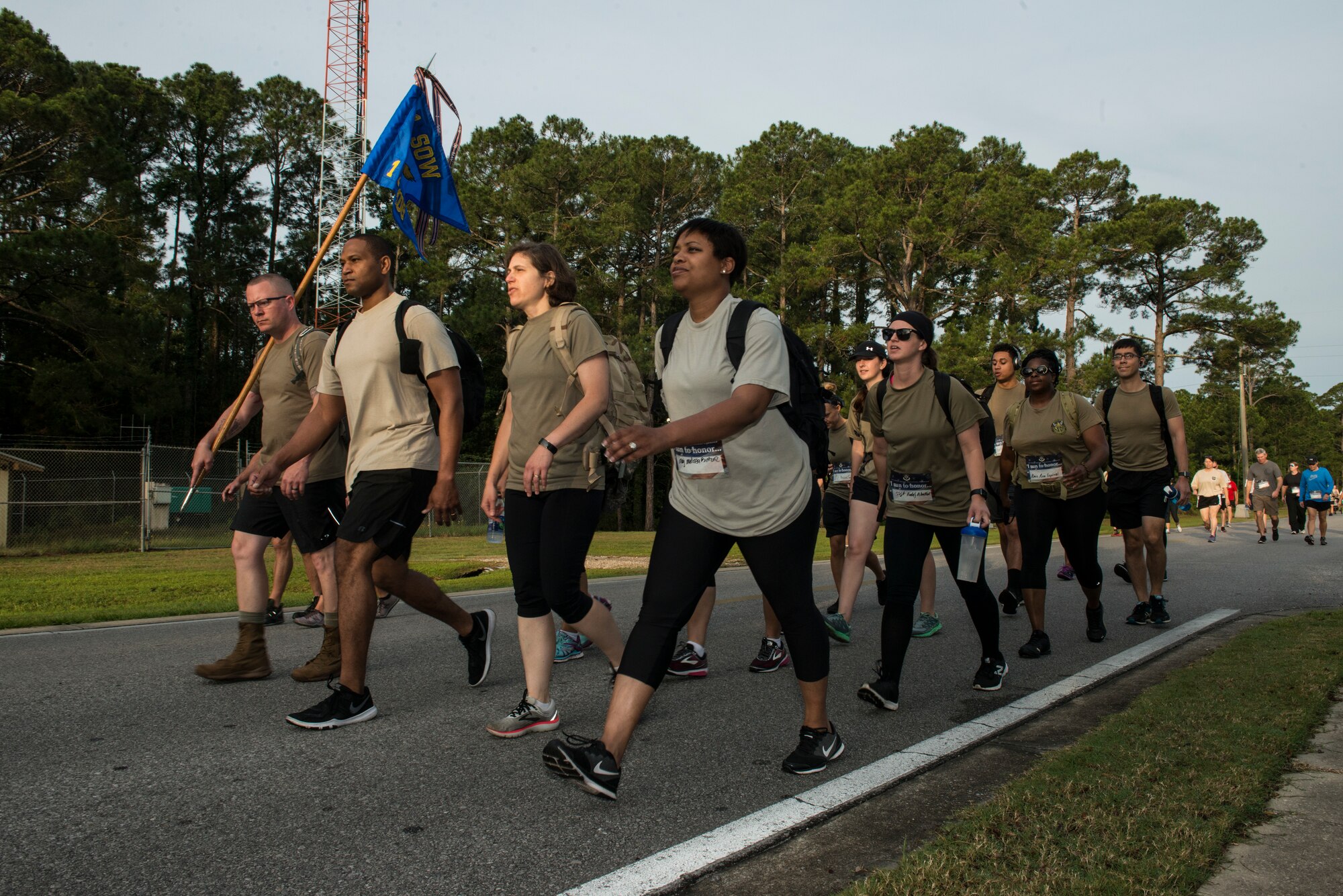 A group of people walking down a road.