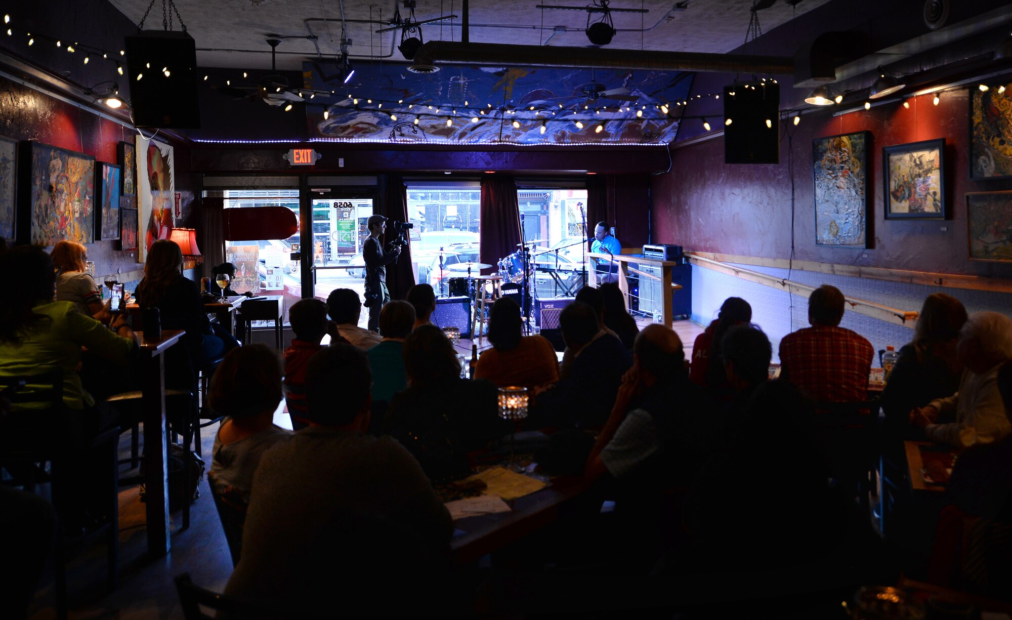 A small gathering of concert-goers and judges listen to the ten finalists of the Omaha Performing Arts Singer-Songwriter Competition at B Side Theatre, Nebraska, May 6, 2019. Airman 1st Class Mario Foreman-Powell, a vocalist with the United States Air Force Heartland of America Band, won first place and the chance to perform at the MAHA Music Festival in Omaha, Nebraska. (U.S. Air Force photo by Josh Plueger)