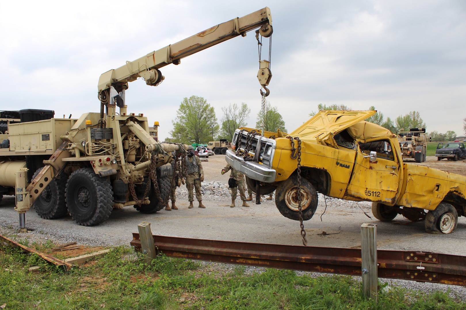 Soldiers from 104th Engineer Construction Company, Task Force Ops, Joint Task Force Civil Support (JTFCS), move damaged vehicles from a road to clear the way for search and rescue teams during Exercise Guardian Response at Muscatatuck, Ind., 30 April, 2019. When directed, JTFCS provides command and control of the 5,200-person Defense Chemical Biological Radiological Nuclear(CBRN) Response Force (DCRF) during a catastrophic crisis in support of civil authorities and the lead federal agency. Vibrant Response/Guardian Response is an annual, combined Command Post Exercise and Field Training Exercise which validates the ability of the DCRF forces to conduct the CBRN Response mission. (U.S. Army photo by 2nd Lt. Corey Maisch/released)