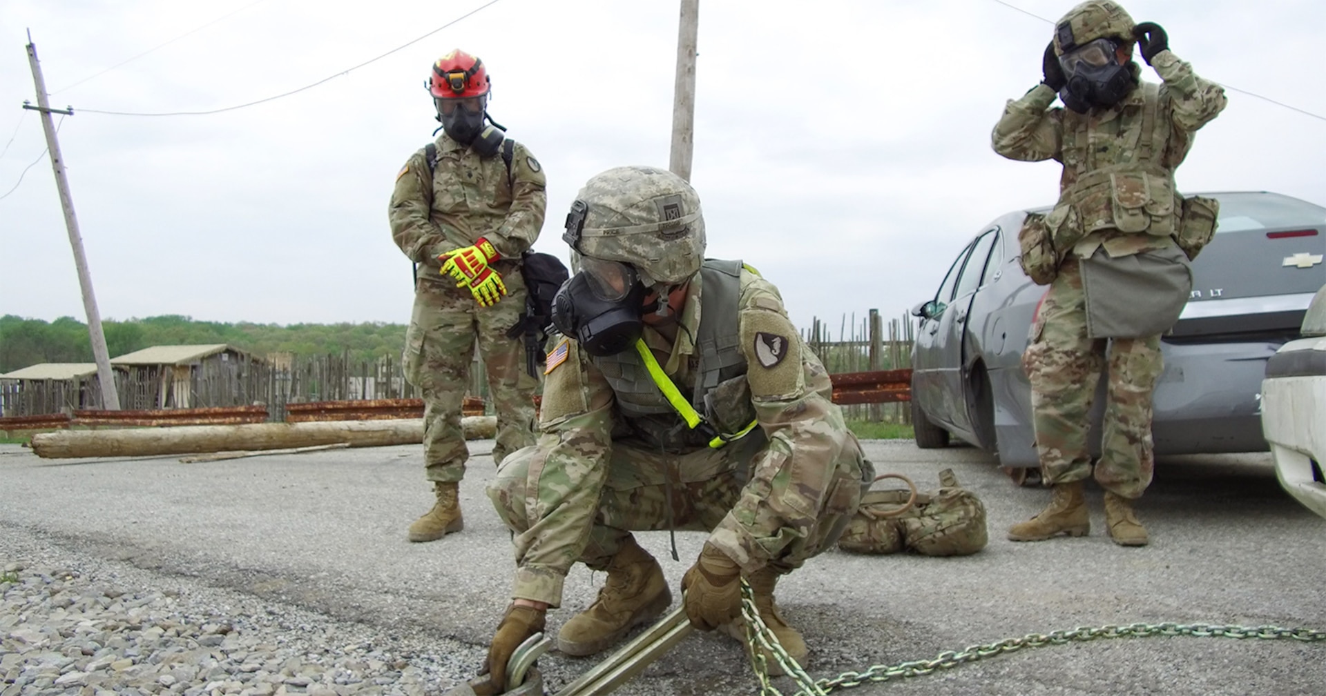 Soldiers with the 104th Engineer Company, 62nd Engineer Battalion, from Ft. Hood, Tx., prepare to use Heavy Expanded Mobility Tactical Trucks (HEMTT) to pull a vehicle from a road at Muscatatuck Urban Training Center in Butlerville, Ind., during Guardian Response 19, a homeland emergency response exercise which tests the ability of the military to respond to a manmade or natural disaster on April 30, 2019. The Soldiers are responding to a city following a mock nuclear detonation, so they must don gas masks and protective equipment while working. (U.S. Army photo by Master Sgt. Brad Staggs/released)