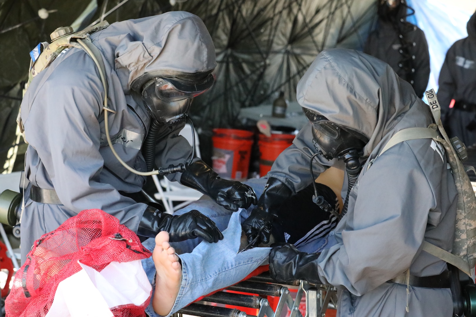 U.S. Army Soldiers of the 66th Military Police Company conduct simulated, urban search and rescue operations in an area with chemical, biological, radiological or nuclear contamination during Guardian Response 19 at Muscatacuck Urban Training Center, Ind., May 5, 2019. Civilian role players acted as inhabitants of the local area, and provided the soldiers with realistic, real world training during the decontamination procedures. (U.S. Army Reserve photos by Sgt. Philip Scaringi/released)