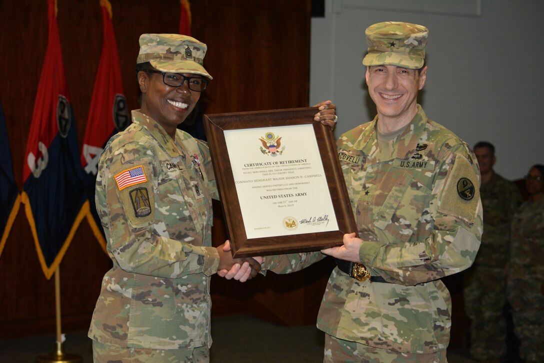 Command Sgt. Maj. Sharon Campbell, outgoing 94th Training Division-Force Sustainment command sergeant major, is presented with her Certificate of Retirement by Brig. Gen. Stephen Iacovelli, 94th TD-FS commanding general during the unit’s change of responsibility ceremony at Fort Lee’s Army Logistics University Bunker Hall. The ceremony bid farewell to Command Sgt. Maj. Sharon Campbell on Mar. 10, 2019 after her tenure as at the 94th TD-FS command sergeant major and retirement from the Army after 38-years of service to her country, welcoming Command Sgt. Maj. Anthony Simpson as the new unit command sergeant major. (Photo by Maj. Ebony Gay, 94th TD-FS Public Affairs Office)