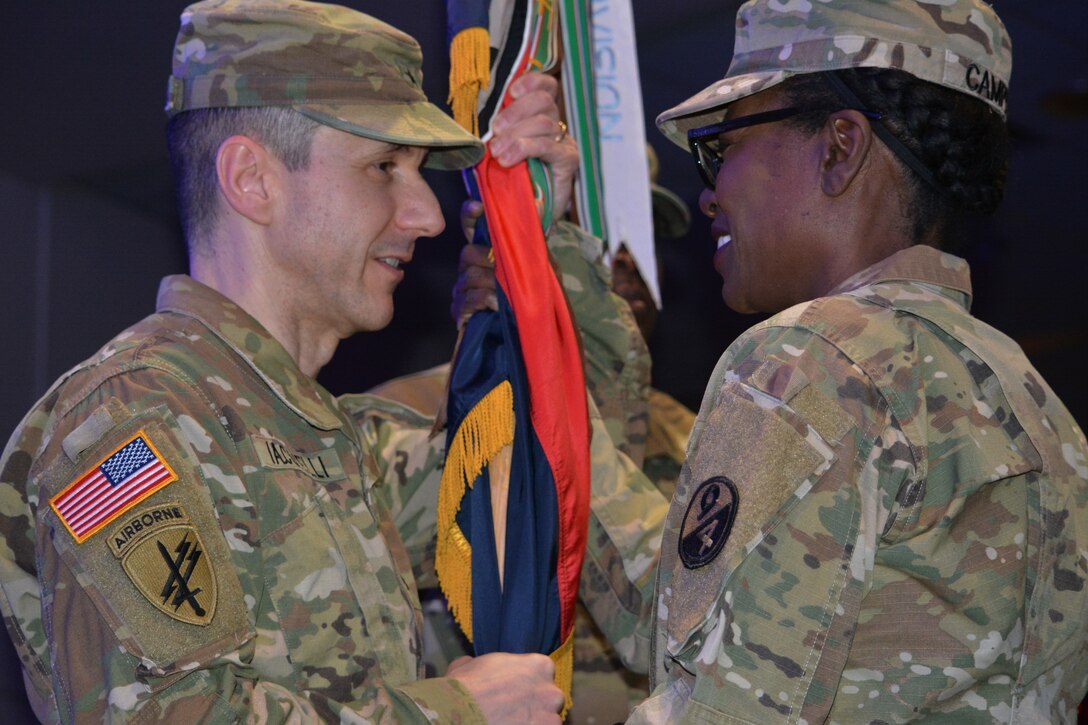 Command Sgt. Maj. Sharon Campbell, outgoing 94th Training Division-Force Sustainment command sergeant major, passes the 94th guidon to Brig. Gen. Stephen Iacovelli as she relinquishes responsibility of the 94th TD-FS during the unit’s change of responsibility ceremony at Fort Lee’s Army Logistics University Bunker Hall. The ceremony bid farewell to Campbell on Mar. 10, 2019 after her tenure at the 94th and retirement from the Army after 38 years of service to her country, welcoming Command Sgt. Maj. Anthony Simpson as the new unit command sergeant major. (Photo by Maj. Ebony Gay, 94th TD-FS Public Affairs Office)