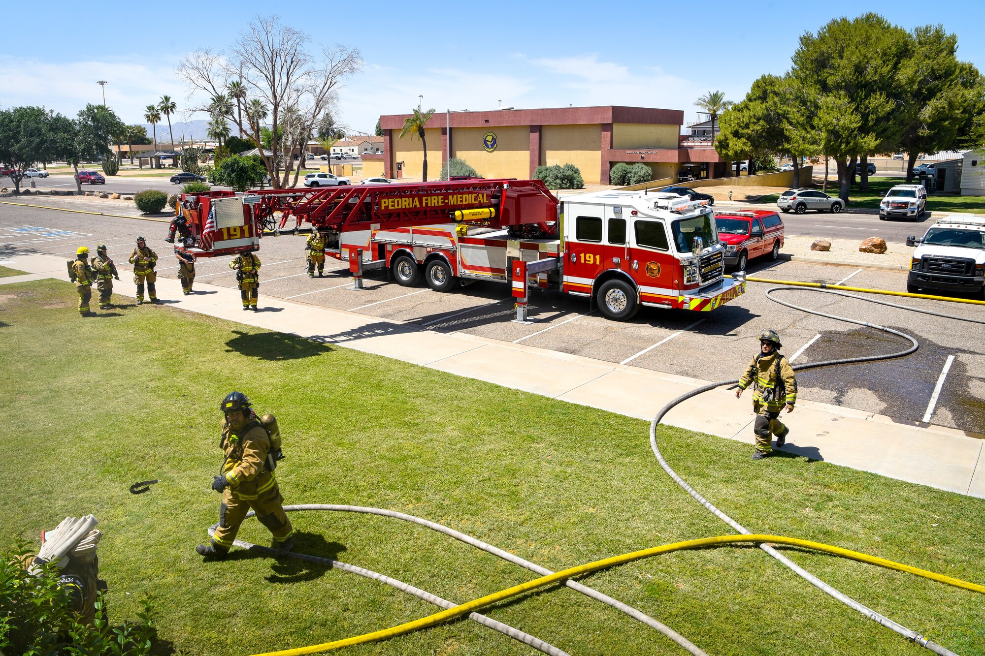 Fire departments from across the west valley work together during a joint training exercise May 3, 2019, at Luke Air Force Base, Ariz. The multi-company standard training mimicked an emergency in which firefighters had to not only subdue the fire, but rescue mannequins with simulated injuries. (U.S. Air Force photo by Airman 1st Class Zoie Cox)