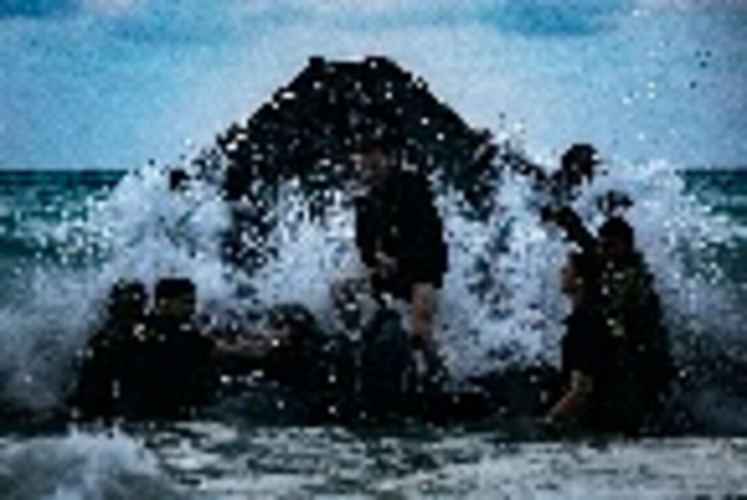 U.S. Marines with 1st, 2nd, and 3rd Radio Battalion conduct a surf passage training event during a Radio Reconnaissance Operator Course, Marine Corps Training Area Bellows, Marine Corps Base Hawaii, May 2, 2019. The course aimed to maintain the units' combat readiness and effectiveness, along with increasing cohesion between the three battalions. (U.S. Marine Corps photo by Cpl. Luke Kuennen)