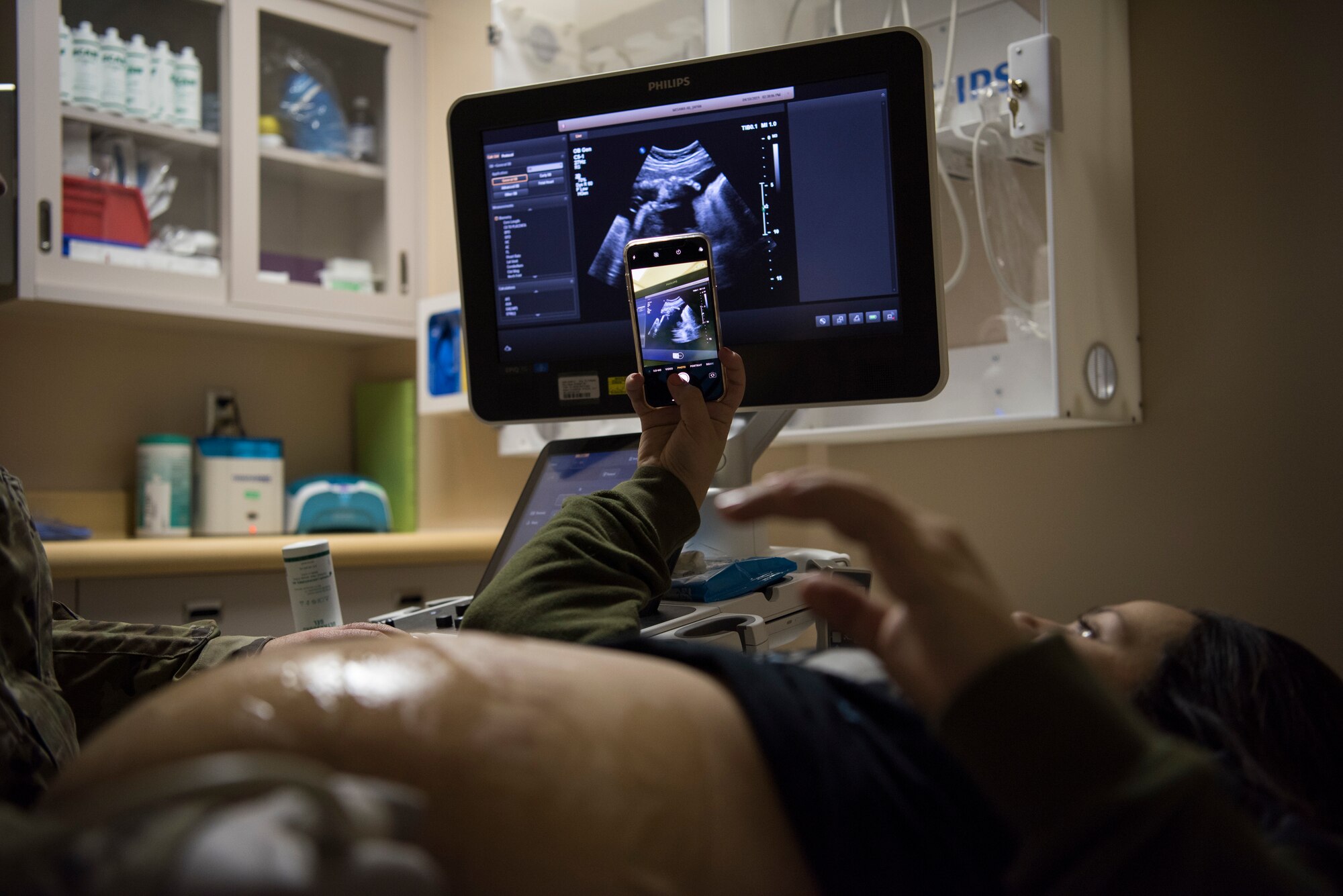 Annalisa McCormick, spouse of Airman 1st Class Kristopher McCormick, a 35th Civil Engineer Squadron pavement and equipment journeyman, takes a photo of her baby during an ultra sound appointment at Misawa Air Base, Japan, April 10, 2019. An ultrasound, also called a sonogram, monitors fetal development and screens for any potential medical concerns. (U.S. Air Force photo by Senior Airman Collette Brooks)