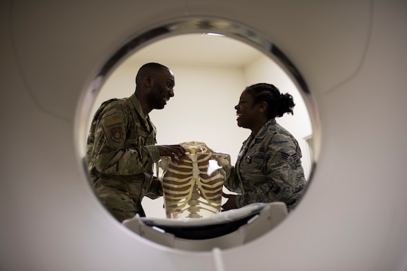 U.S. Air Force Senior Airmen William Gathers III, left, and Shirell Montague, right, both 35th Surgical Operations Squadron radiology technologists, have a laugh at work improving flight morale while inspecting a skeleton model at Misawa Air Base, Japan, April 10, 2019. Medical professionals use human skeletons as learning tools aiding in training by expanding Airmen’s knowledge and skills. (U.S. Air Force photo by Senior Airman Collette Brooks)