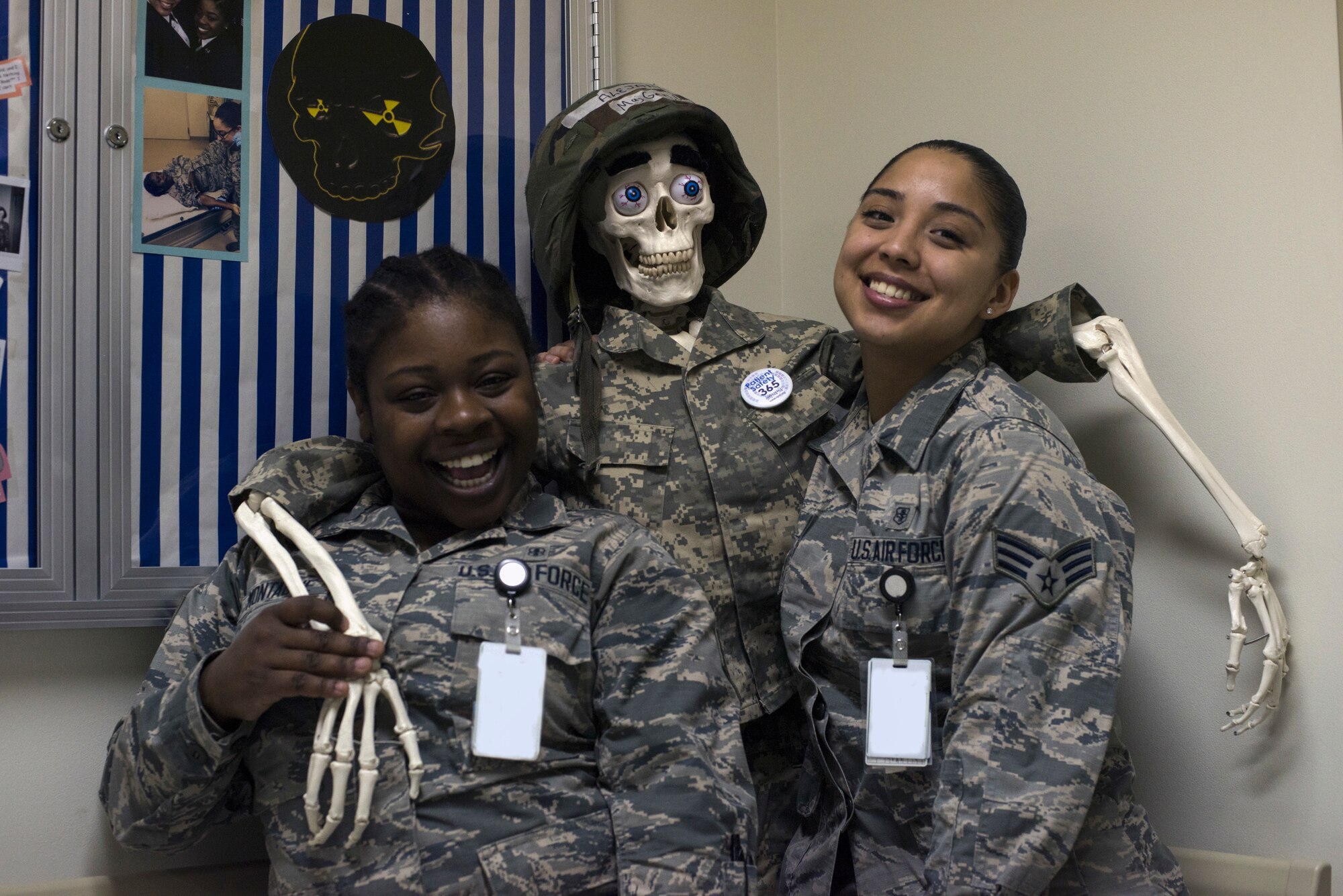 U.S. Air Force Senior Airman Shirell Montague, left, a 35th Surgical Operations Squadron radiology technologist, and Senior Airman Darae Aguilar, a 35th SGC diagnostic imaging technician, pose with the radiologist mascot, “Maj. Gen. Alejandro,” at Misawa Air Base, Japan, April 10, 2019. Team Misawa members can pose with the mascot for comedy aiding in unit morale and readiness. (U.S. Air Force photo by Senior Airman Collette Brooks)