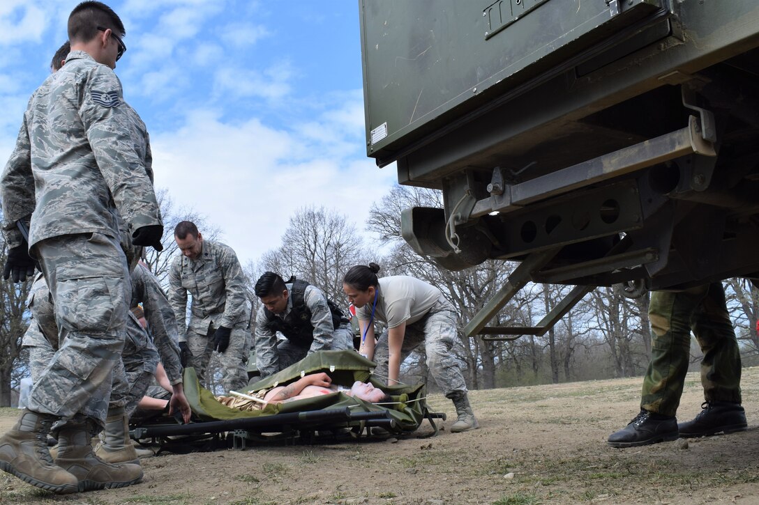 Airmen from the 86th Medical Group, Ramstein Air Base, Germany, participate in a multinational medical exercise drill during Vigorous Warrior 19, Cincu Military Base, Romania, April 8, 2019. During the exercise, medical personnel kept up a rigorous operations tempo that included more than 1,000 scenarios, 300 medical actions, and more than 1,500 simulated casualties. (U.S. Air Force photo by 1st Lt. Andrew Layton)