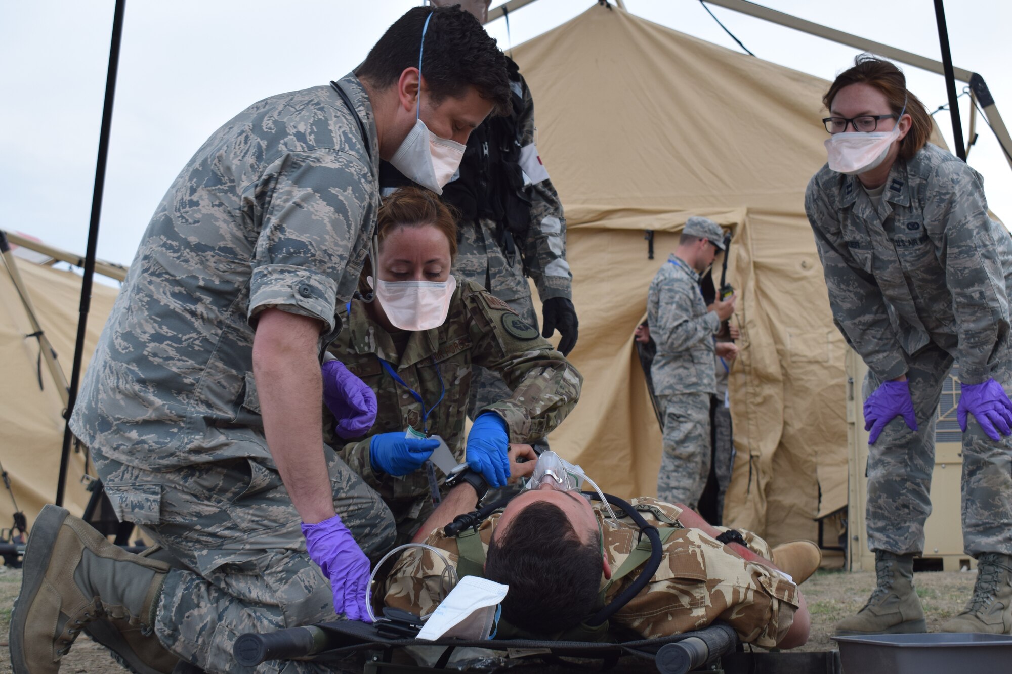 Airmen from the 86th Medical Group, Ramstein Air Base, Germany, participate in a multinational medical exercise drill during Vigorous Warrior 19, Cincu Military Base, Romania, April 8, 2019. Vigorous Warrior 19 is NATO’s largest-ever military medical exercise, uniting more than 2,500 participants from 39 countries to exercise experimental doctrinal concepts and test their medical assets together in a dynamic, multinational environment. (U.S. Air Force photo by 1st Lt. Andrew Layton)
