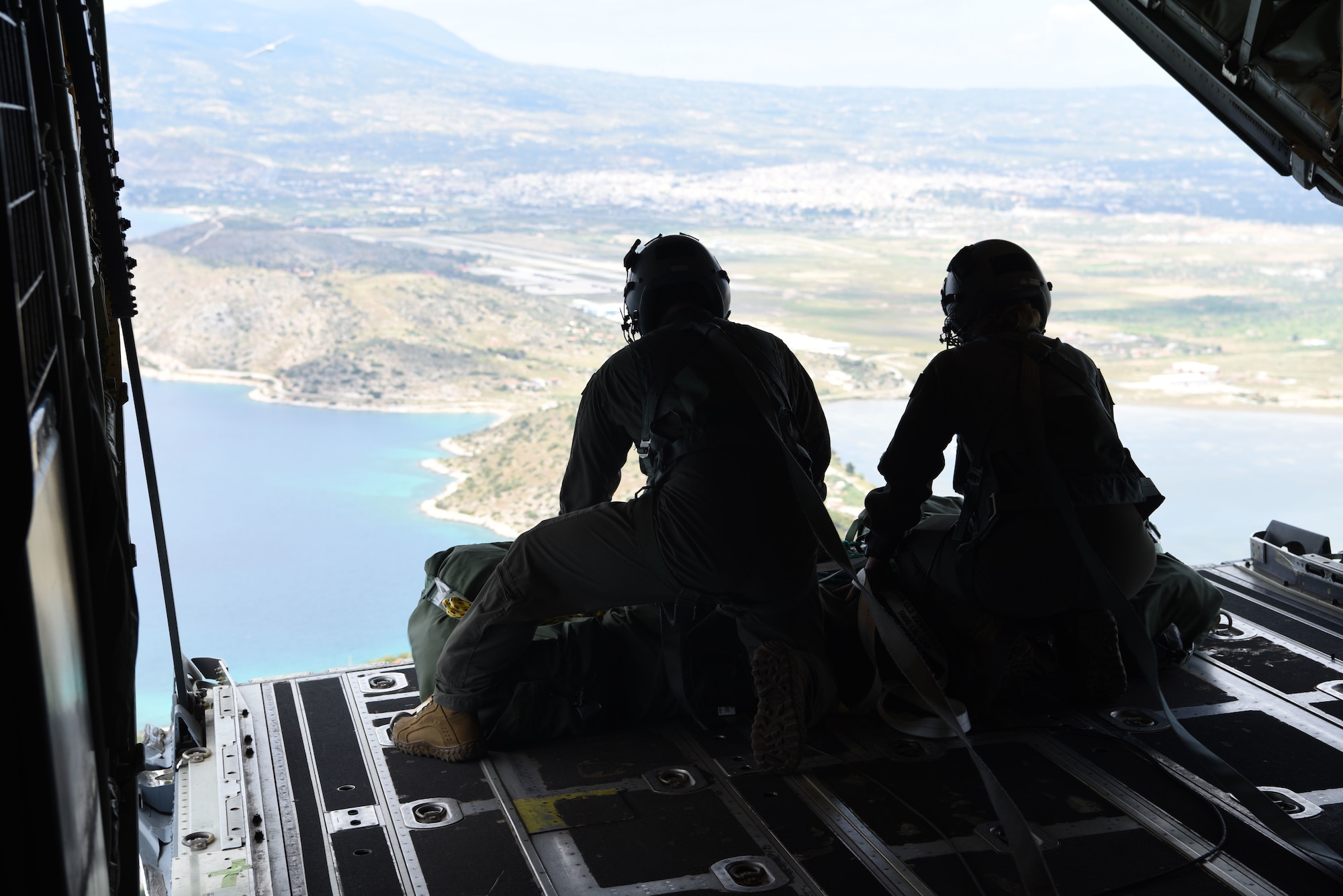 Two U.S. Air Force loadmasters from the 37th Airlift Squadron, Ramstein Air Base, Germany, prepare to drop cargo out of a C-130J Super Hercules during exercise Stolen Cerberus VI, May 8, 2019, off the coast of Greece. Stolen Cerberus is an annual bilateral training event with the Hellenic Air Force designed to enhance interoperability and airlift capabilities through realistic joint air operations training, including aeromedical evacuation operations and airlift and airdrop capabilities.