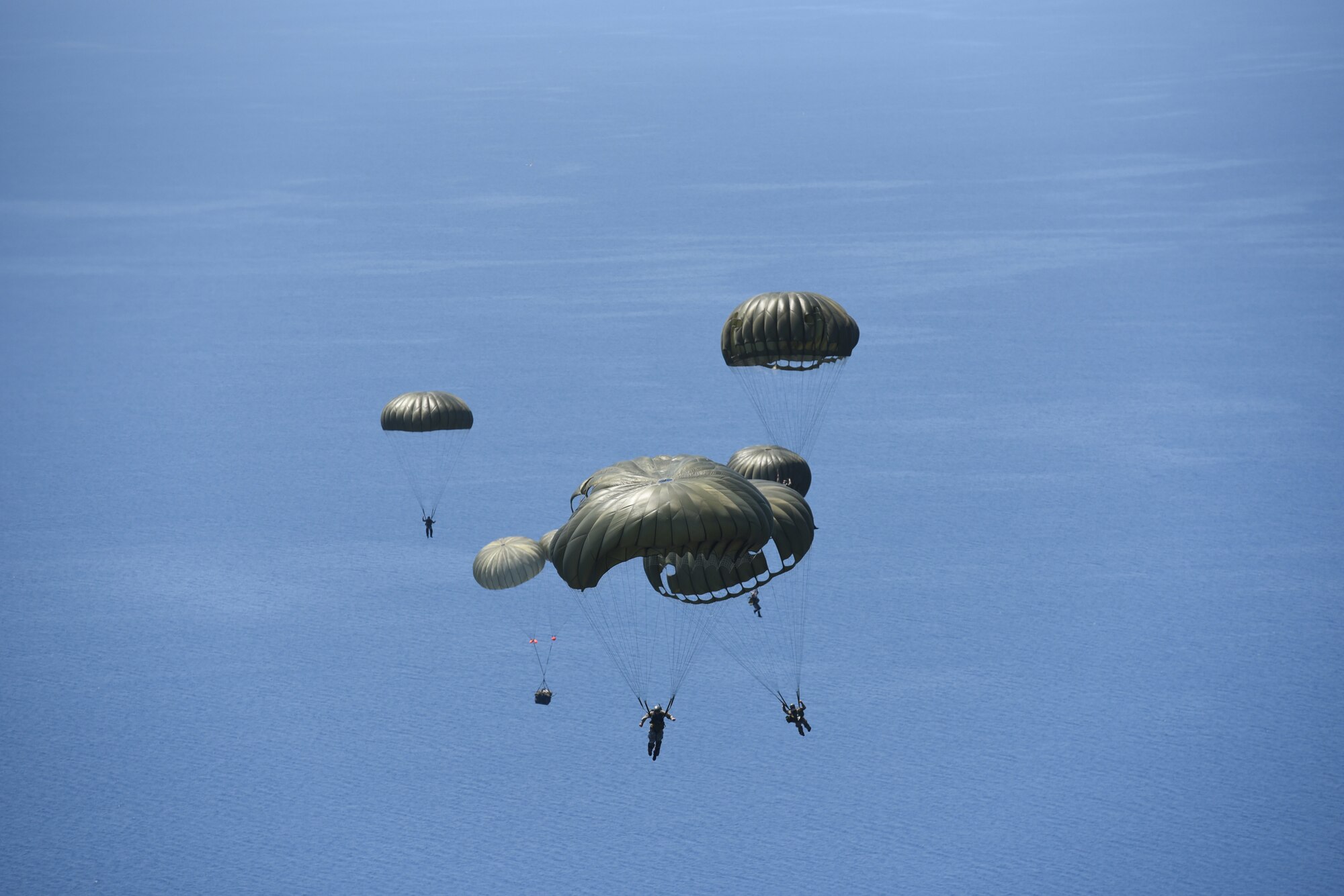 Hellenic military members prepare to land in the Aegean Sea, after jumping out of a U.S. Air Force C-130J Super Hercules, during exercise Stolen Cerberus VI, May 9, 2019, off the coast of Greece. Stolen Cerberus is an annual bilateral training event with the Hellenic air force designed to enhance interoperability and airlift capabilities through realistic joint air operations training, including aeromedical evacuation operations and airlift and airdrop capabilities.