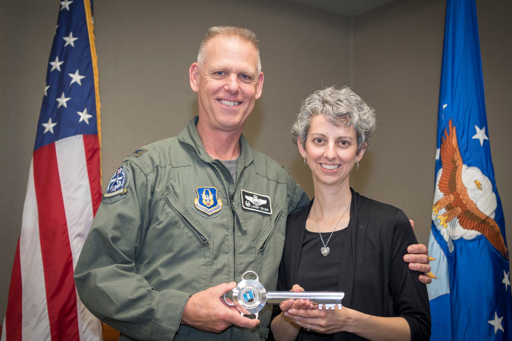 Rachel Grasmick, 434th Air Refueling Wing Key Spouse volunteer and Col. Larry Shaw, 434th ARW commander, pose for a photo after she received a key spouse award during a volunteer appreciation event at Grissom Air Reserve Base, Indiana, May 4, 2019. Grasmick received the 2018 Key Spouse award for her service to the program donating more than 250 hours supporting Airmen and family of Grissom service members. (U.S. Air Force photo/Master Sgt. Ben Mota)