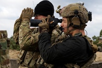 Air Force Senior Airman Nacie Calarco, a joint terminal attack controller with the 19th Air Support Operations Squadron supporting the 2nd Air Support Operations Squadron out of Vilseck, Germany, surveys the impact zone after a live-fire exercise during Dynamic Front 2019 in Torun, Poland, March 5, 2019.
