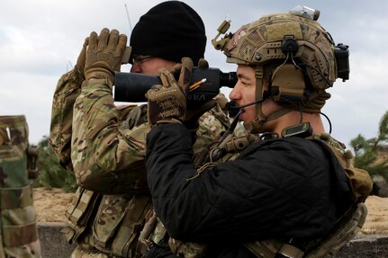 Air Force Senior Airman Nacie Calarco, a joint terminal attack controller with the 19th Air Support Operations Squadron supporting the 2nd Air Support Operations Squadron out of Vilseck, Germany, surveys the impact zone after a live-fire exercise during Dynamic Front 2019 in Torun, Poland, March 5, 2019.