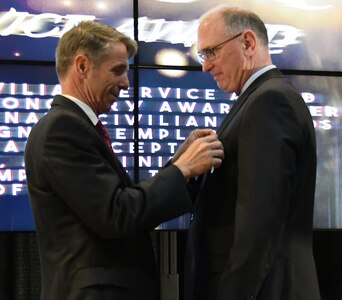 IMAGE: Fredericksburg, Va. (May 10, 2019) – U.S. Rep. Rob Wittman pins the Department of the Navy Superior Civilian Service Medal on Gilbert Goddin at the Naval Surface Warfare Center Dahlgren Division (NSWCDD) annual honor awards ceremony. Goddin was recognized for his remarkable management abilities, innovative thinking, and outstanding leadership serving as the chief systems engineer for the Electromagnetic Railgun and the Hypervelocity Gun Weapon System development and integration efforts from May 2015 to November 2017.  (U.S. Navy photo/Released)