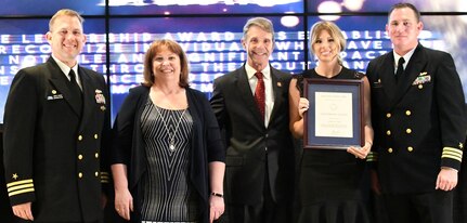 IMAGE: FREDERICKSBURG, Va. (May 10, 2019) – Ashby Hall holds the Leadership Award moments after receiving it from Naval Surface Warfare Center Dahlgren Division (NSWCDD) leadership at the command’s annual honor awards ceremony. Ashby was recognized for her outstanding leadership ability that resulted in a culture of change and innovation. Standing left to right: NSWCDD Dam Neck Activity Commanding Officer Cmdr. Andrew Hoffman; NSWCDD Deputy Technical Director Angela Beach; U.S. Rep. Rob Wittman; Hall; and NSWCDD Commanding Officer Cmdr. Stephen ‘Casey’ Plew.  (U.S. Navy photo/Released)