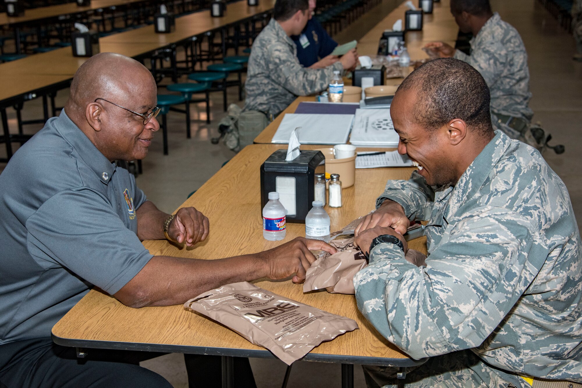 Air Mobility Command civic leader, Thomas Randall, visits with a trainee during a stop for an MRE lunch at Joint Base San Antonio-Lackland, May 2, 2019.  The civic leaders toured the 37th Training Wing, also known as the “Gateway Wing,” as guests of AMC Cmmander Gen. Maryanne Miller. (U.S. Air Force photo by Traci Howells)