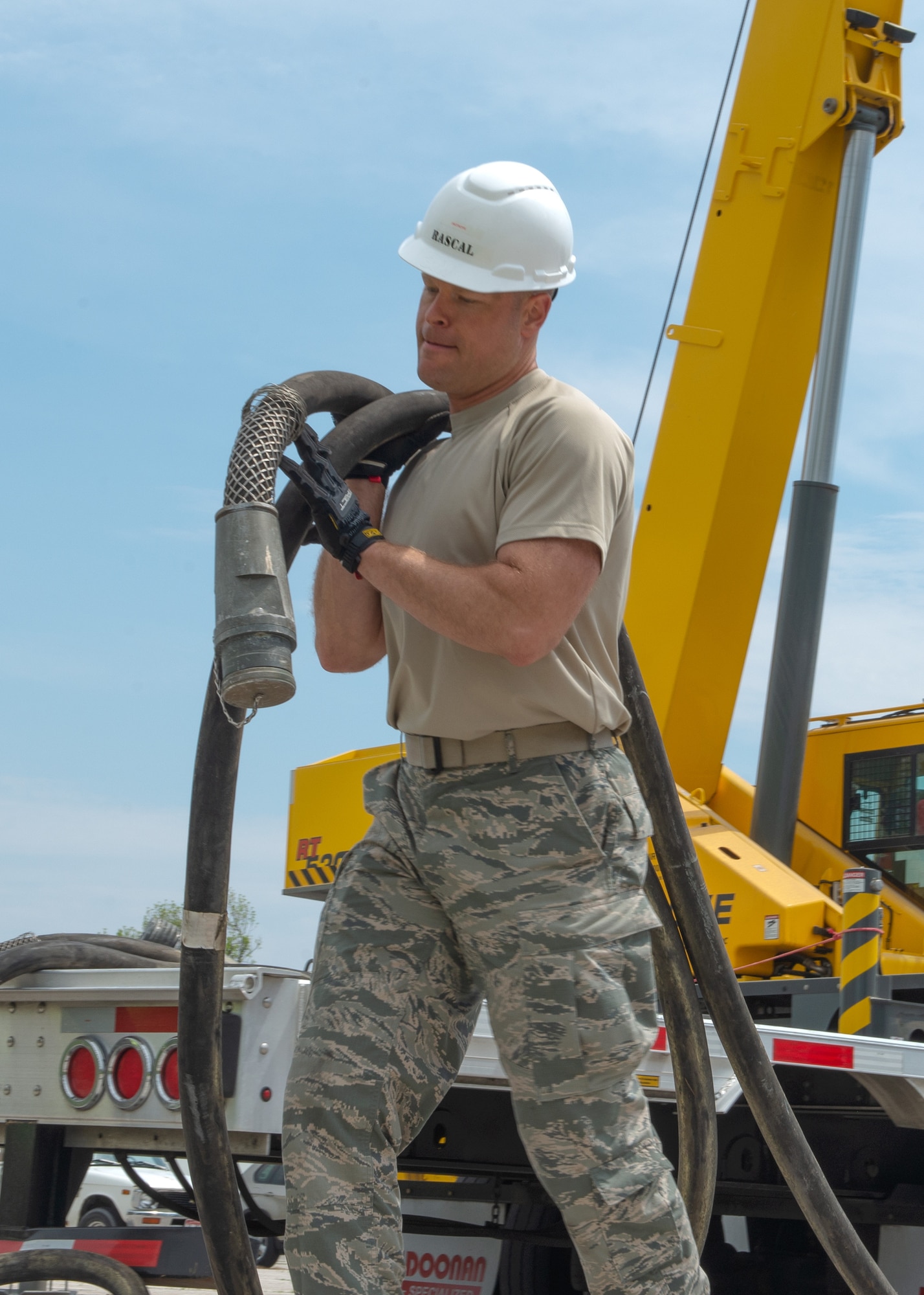 Master Sgt. Mason Lucas, a test measurement and diagnostic equipment quality manager assigned to the 4th Component Maintenance Squadron at Seymour Johnson Air Force Base, North Carolina, carries power cables out of a integrated unit (INU) tactical shelter May 6, 2019, at Offutt Air Force Base, Nebraska. The INU is the main scheduling unit for the Rapid Assistance Support for Calibration unit brought in to reestablish the base’s capability to calibrate equipment, which was lost in the flood. (U.S. Air Force photo by L. Cunningham)