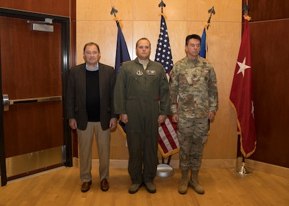 Tech Sgt. Sean Price, a boom operator with the 151st Air Refueling Wing, Utah Air National Guard, is presented with the Utah Cross by Utah Gov. Gary Herbert and the state adjutant general, Maj. Gen. Jefferson Burton, April 22, 2019, at Roland R. Wright Air National Guard Base, Salt Lake City, Utah. Price was presented with the Utah Cross for providing lifesaving first aid to an injured driver.