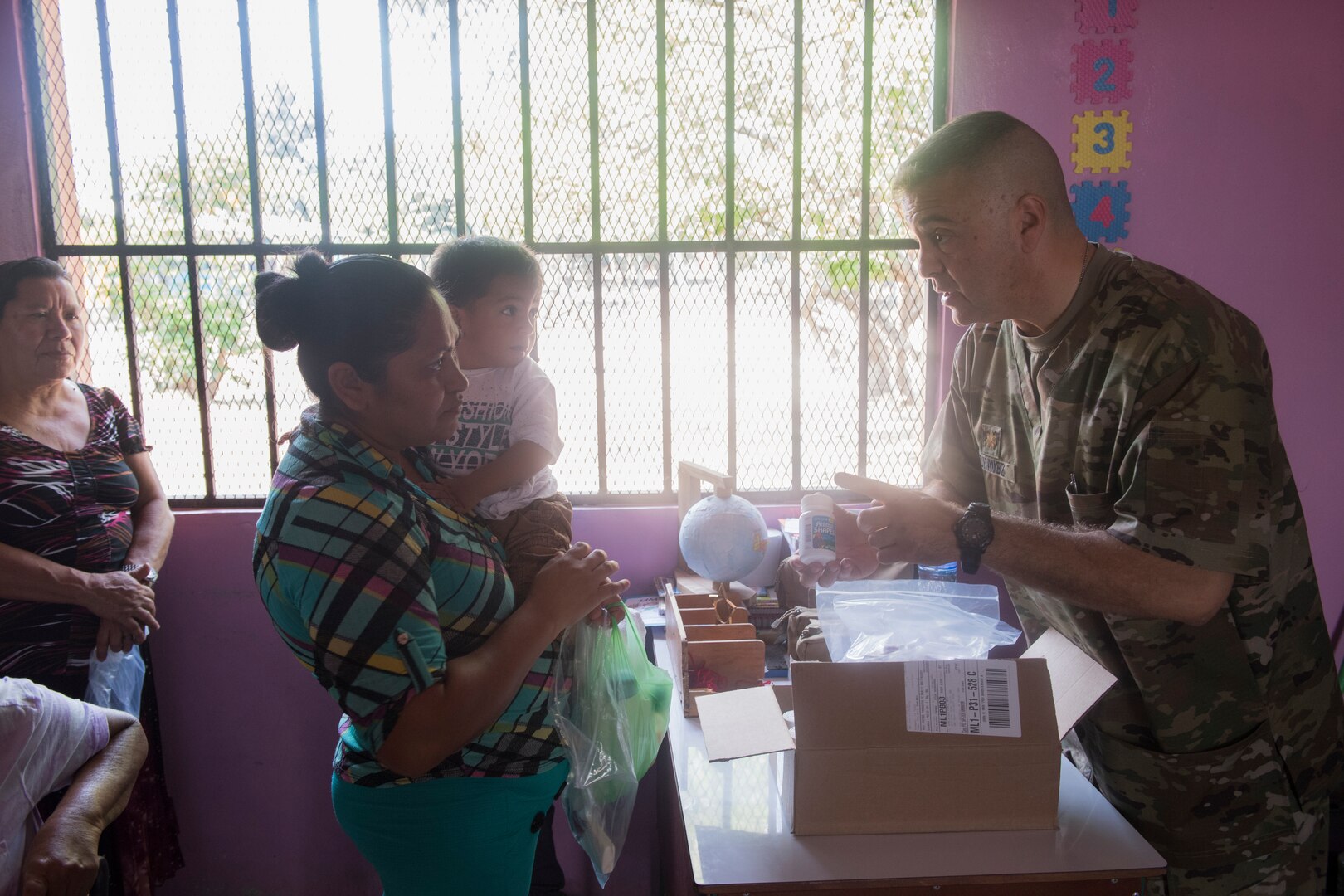 U.S. Army Maj. Jorge Chavez, Joint Task Force – Bravo Medical Element public  health nurse, hands vitamins to a Honduran citizen during a Medical Readiness Training Exercise (MEDRETE), May 9, 2019, in El Paraiso, Honduras. Members of JTF-B partnered with the Honduran Military and Ministry of Health to provide health care services for more than 1,300 Honduran citizens reaching a third of the citizens in the towns of Argelia, Santa Maria and Las Dificultades in the El Paraiso Department. The goal of the mission was to provide the medical staff training in their areas of expertise as well as strengthen partnerships with the Honduran allies. (U.S. Air Force photo by Staff Sgt. Eric Summers Jr.)